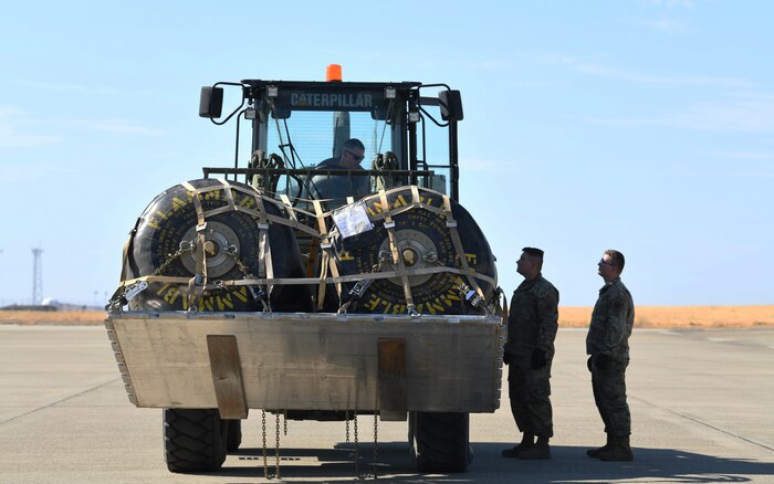 Tech. Sgt. Marshall Spooner, 9th Logistics Readiness Squadron, Fuels Flight NCOIC of transport and mobility, drives a forklift carrying fuel and instructs other team members on procedures during an exercise July 9, 2021, at Beale Air Force Base, California.