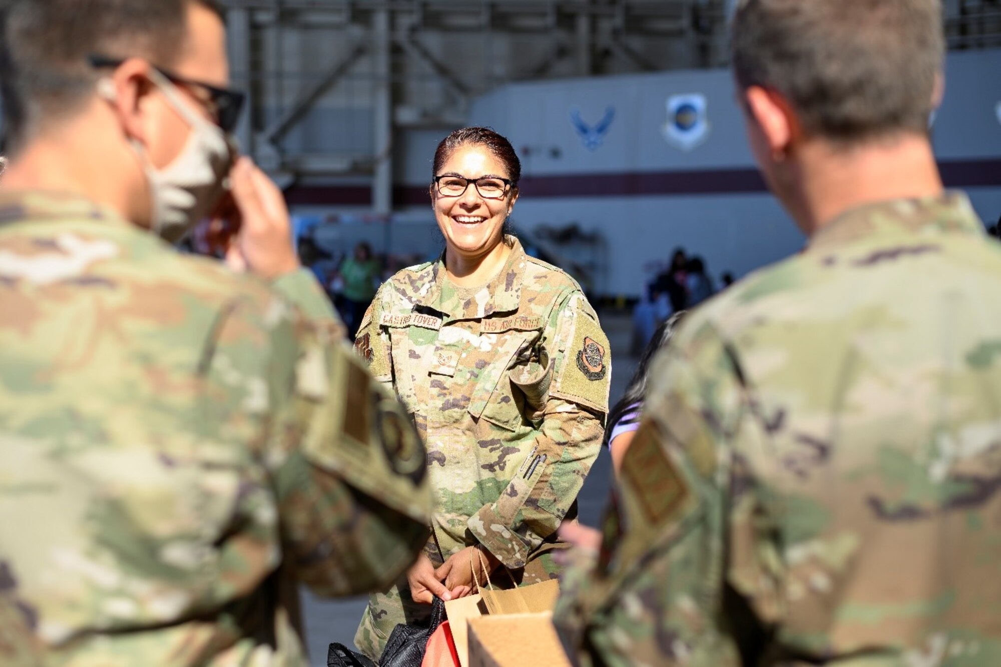 Airmen from Travis Air Force Base, California, speak to each other during the Back-to-School Brigade, a giveaway of free school supplies for local students July 23, 2021, at Travis AFB. The Back-to-School Brigade is an annual tradition for the base to ensure all returning students have the resources they need ahead of the start of the new school year. (U.S. Air Force photo by Staff Sgt. Christian Conrad)