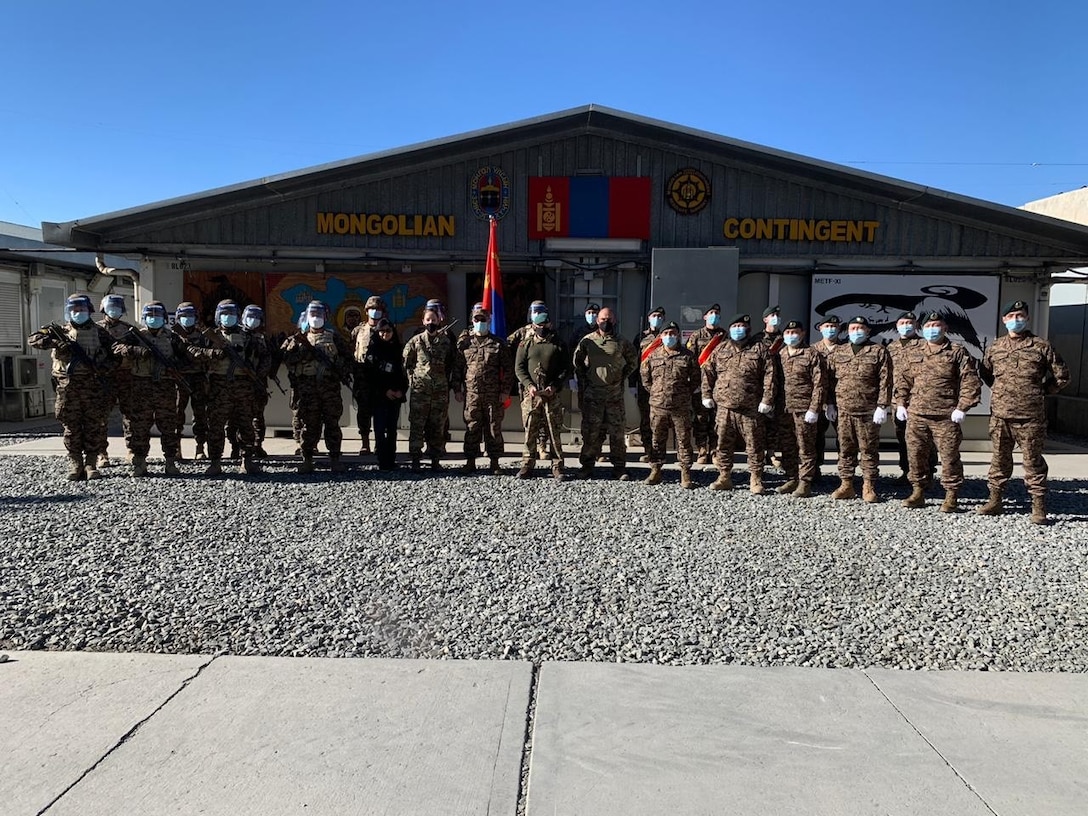 Alaska Army National Guard Capt. Jessica Miller and Sgt. 1st Class Juan Restrepo spend time with their Mongolian counterparts during the last rotation of the Mongolian Expeditionary Task Force liaison program in New Kabul Compound, Afghanistan, December 2020 - July 2021. This program started in 2003 shortly after the country was selected for Alaska’s state partnership program, and finally came to an end in 2021 when the camp was signed over to the Afghan Army, the METF returned to Mongolia, and the Alaska National Guardsmen returned to Alaska. (Courtesy photo)