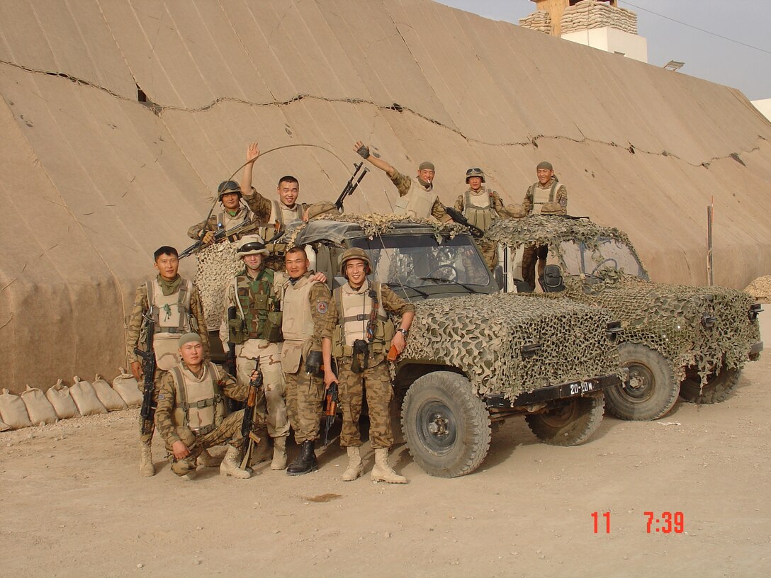 Lt. Col. Steve Wilson poses for a photo with his Mongolian counterparts in Iraq, May 11, 2004. Wilson was the first liaison to accompany the Mongolian Armed Forces on a deployment during the Global War on Terrorism as part of the state partnership program. The SPP is a program that links a state’s National Guard with the armed forces or equivalent of a partner country in a cooperative, mutually beneficial relationship. (Courtesy photo)