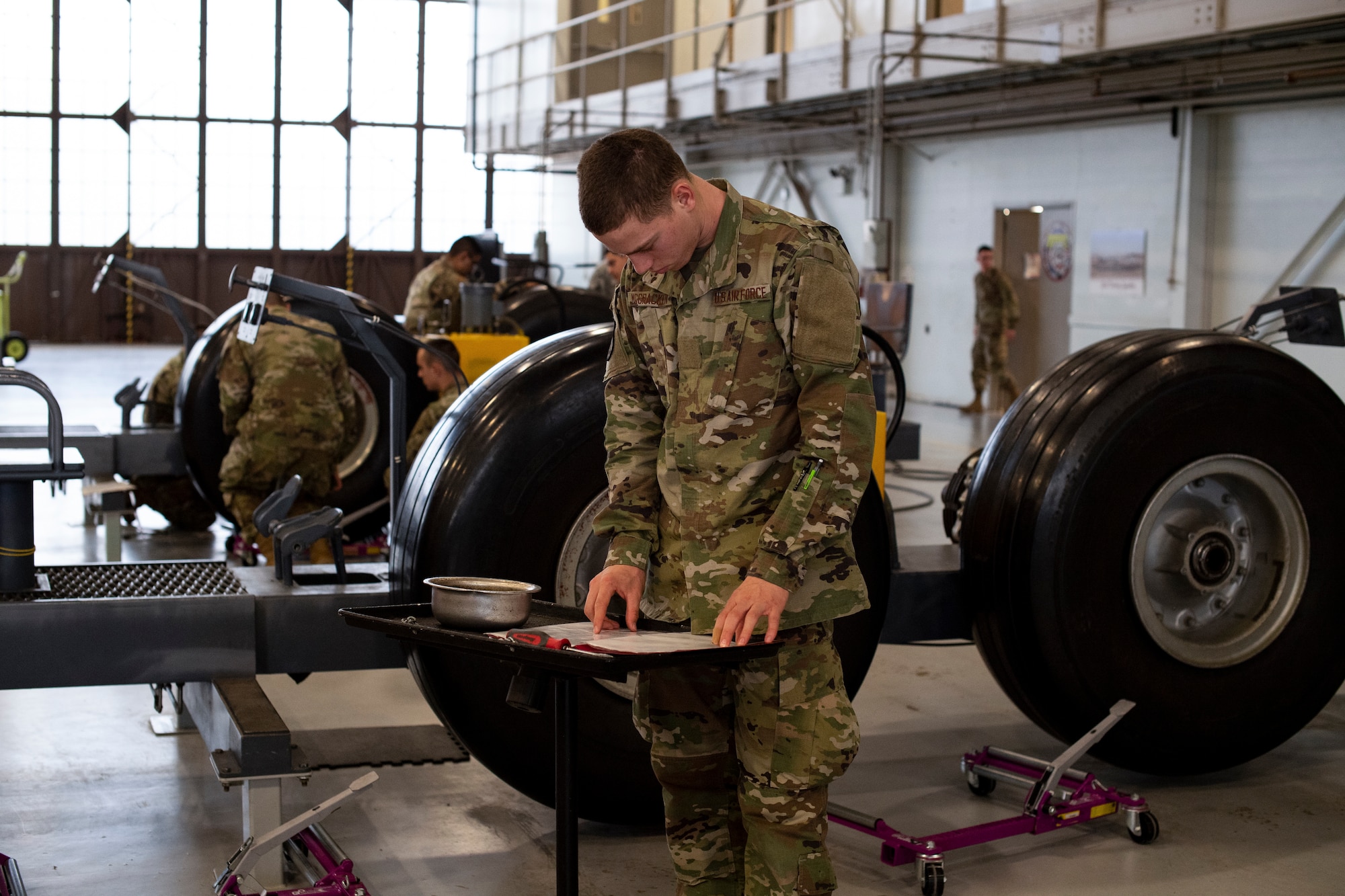 Airman Carter McCracken, a 362nd Training Squadron heavy crew chief student, reads through technical order instructions as he works through the wheel removal process on a landing gear trainer at Sheppard Air Force Base, Texas, March 3, 2020. McCracken and other students in his class were part of a test bed to gauge the effectiveness of using virtual, augmented and mixed realities to train Airmen in aircraft maintenance career fields. (U.S. Air Force photo by John Ingle)