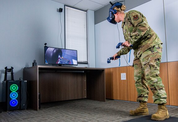 Staff Sgt. Renee Scherf, Detachment 23 curriculum engineer and MC-130H Combat Talon II subject matter expert, demonstrates a virtual reality training system at Sheppard Air Force Base, Texas, June 16, 2021. Members of Detachment 23’s Tech Training Transformation are responsible for re-engineering tech training. Their cutting-edge program utilizes virtual reality training systems and artificial intelligence, among other modalities, to transform the Airmen development process.