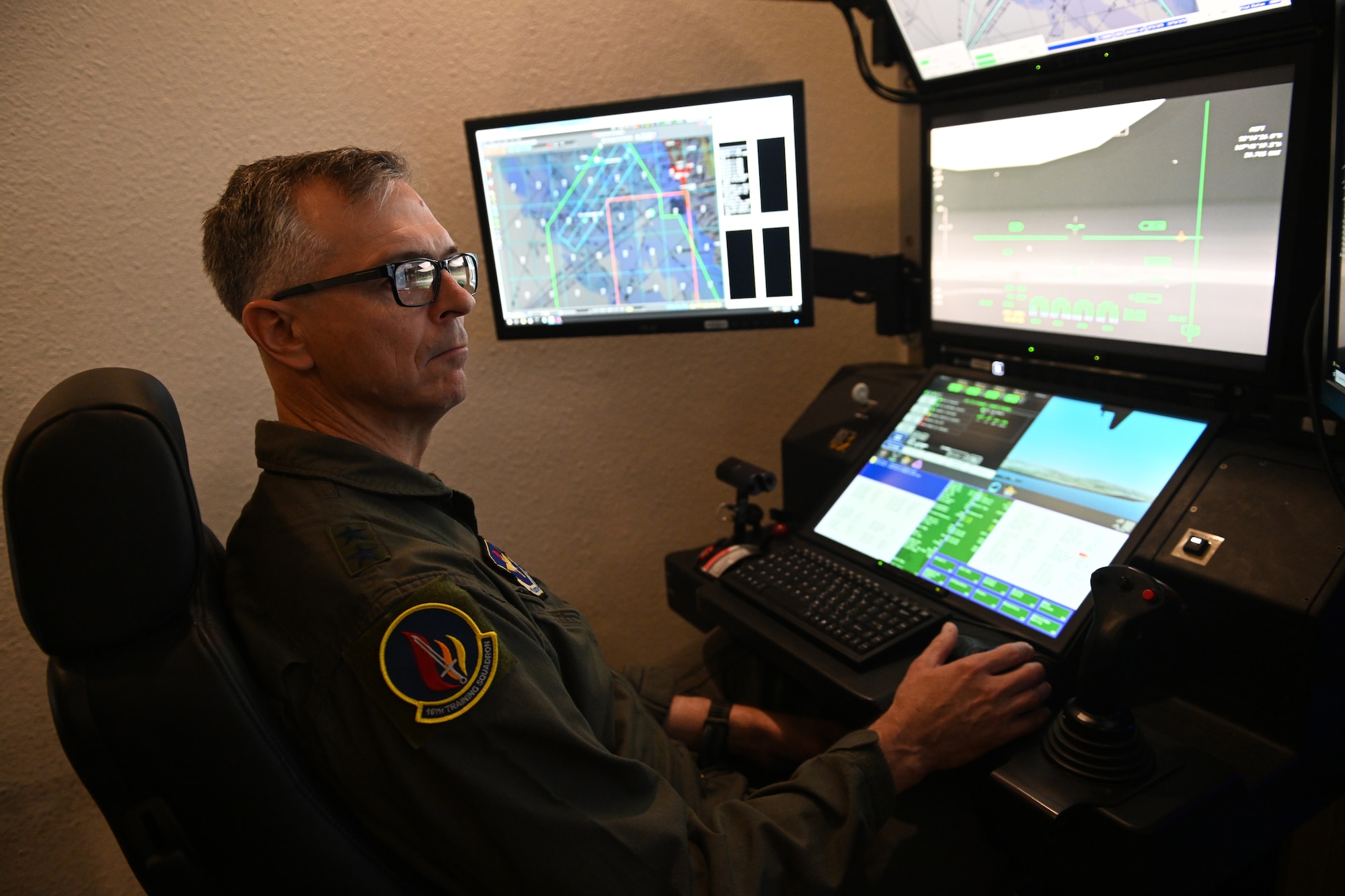 Maj. Gen. Craig D. Wills, 19th Air Force commander, flies an MQ-9 Reaper simulator, July 20, 2021, on Holloman Air Force Base, N.M. The command team held three all-calls with the wing, and spoke on the importance of training, readiness and how our Airmen give the U.S. Air Force a competitive edge in our fight against U.S. adversaries. (U.S. Air Force photo by Staff Sgt. Christopher S. Sparks)