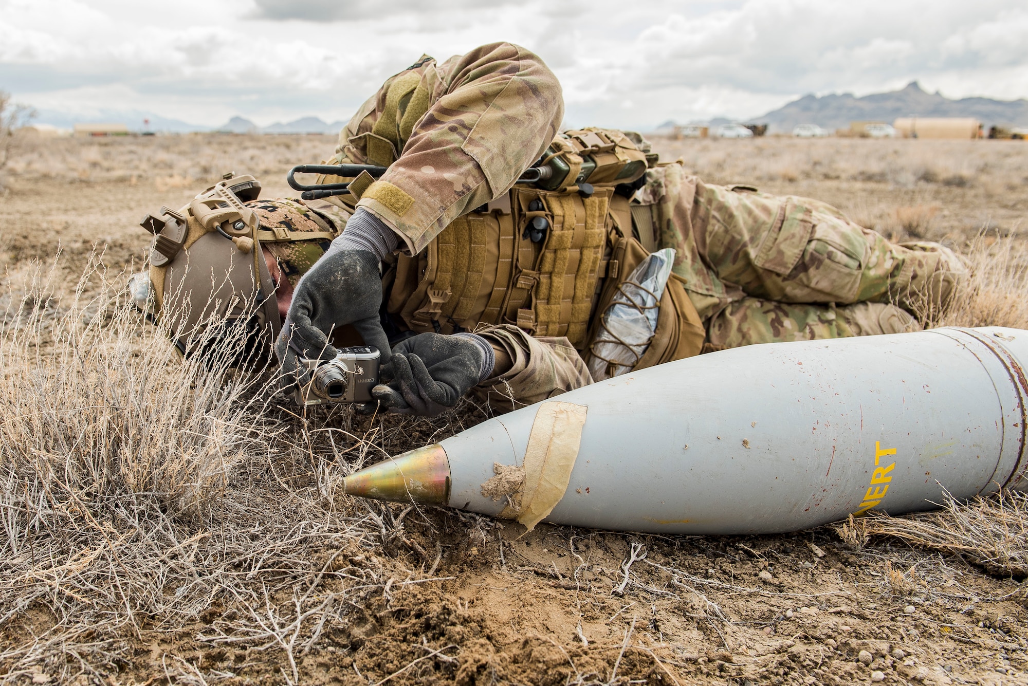 An Explosive Ordinance Disposal Airman assigned to the 27th Special Operations Mission Support Team documents an inert training unexploded ordinance during a 27th Special Operations Wing operational readiness exercise at Dugway Proving Grounds, Utah, March 22, 2021. The Mission Support Team concept provides a way forward in building small, scattered teams capable of operating independent of main operating bases. (U.S. Air Force photo by Senior Airman Vernon R. Walter III)