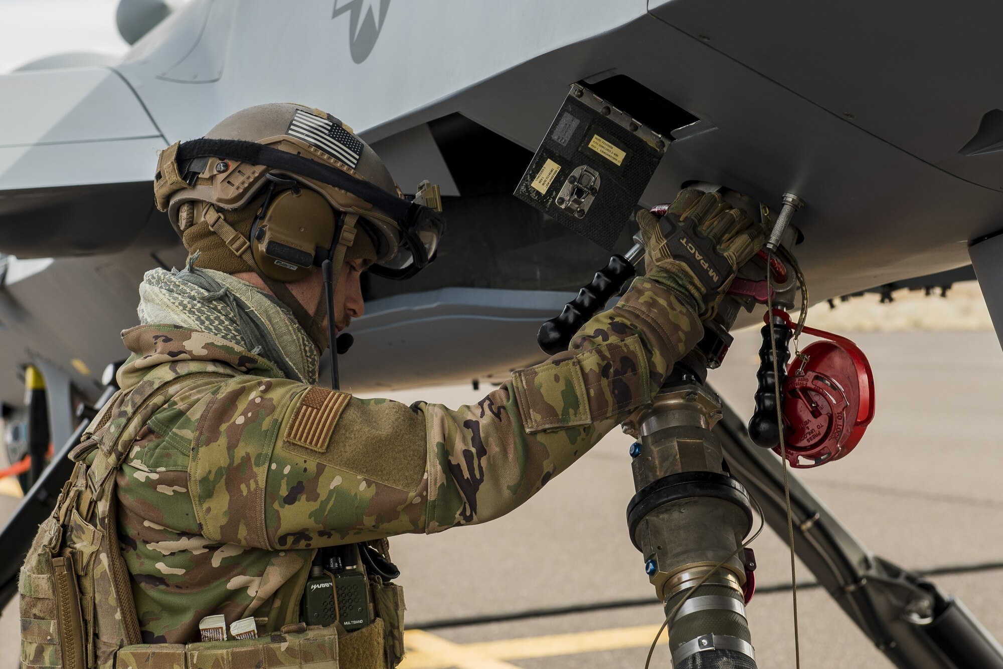 A Forward Area Refueling Point Airman assigned to the 27th Special Operations Mission Support Team refuel a MQ-9 Reaper unmanned aircraft during the 27th Special Operations Wing operational readiness exercise at Dugway Proving Grounds, Utah, March 22, 2021. The Mission Support Team concept provides a way forward in building small, scattered teams capable of operating independent of main operating bases. (U.S. Air Force photo by Senior Airman Vernon R. Walter III)