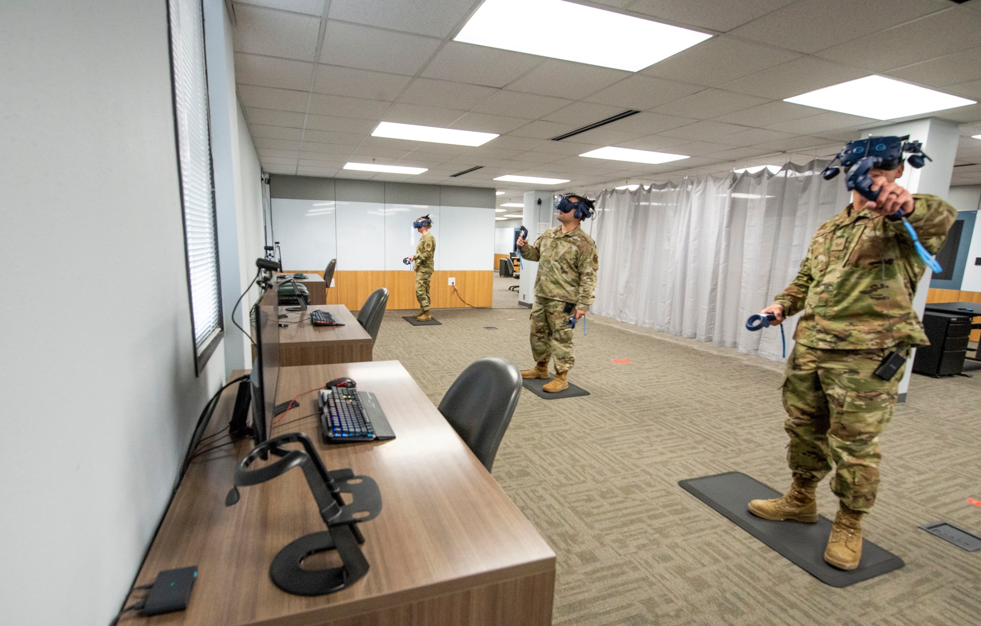 Air Force Tech Sgt. Casey Michalski (left), Staff Sgt. Kevin Lassen, and Staff Sgt. Renee Scherf, Detachment 23 curriculum engineers, test virtual reality training systems. Members of Detachment 23’s Tech Training Transformation are part of Air Education and Training Command and responsible for re-engineering tech training. Their cutting-edge program utilizes virtual reality training systems and artificial intelligence, among other modalities, to transform the Airmen development process. (Photo by Air Force Staff Sgt Keith James)