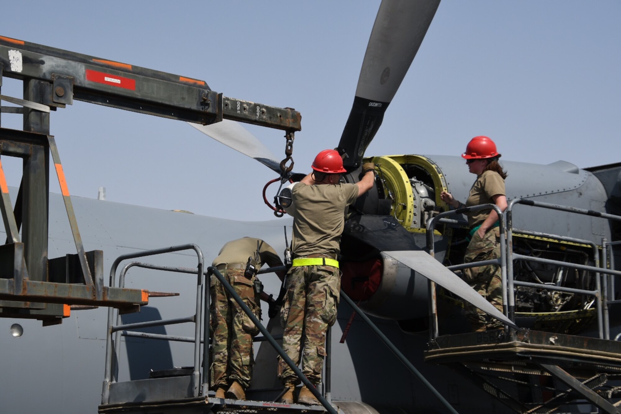 Members deployed from Maxwell Air Force Base, Alabama, and assigned to the 386th Expeditionary Aircraft Maintenance Squadron change a propeller on a C-130 Hercules. The EAMXS works 24-hour operations year-round to keep the C-130 Hercules’ in flight to accomplish the mission of fight to win today and to provide warfighter support in the area of responsibility. (Courtesy Photo)