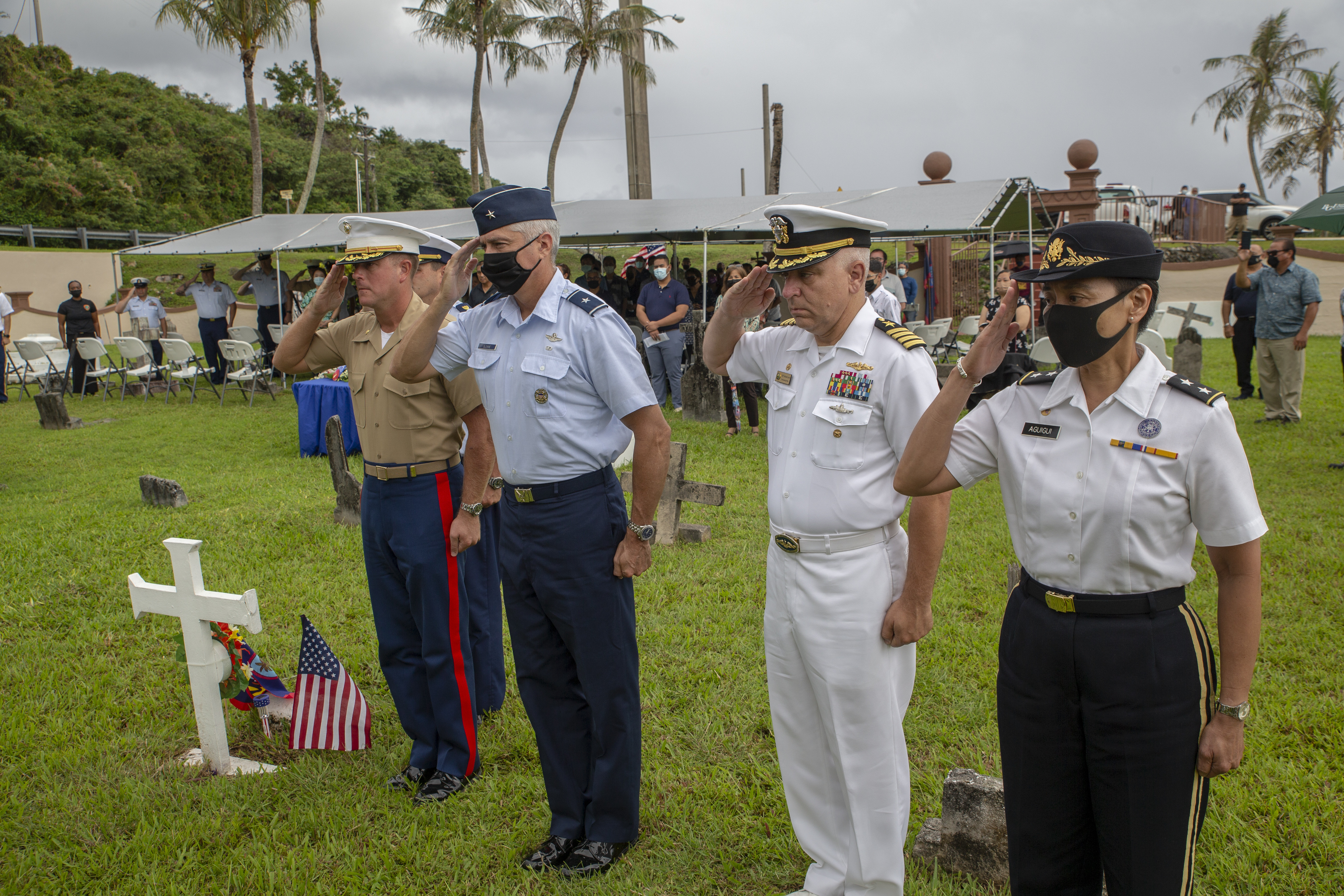 Senior leaders render a salute during a memorial service at Sumay Cemetery on U.S. Naval Base Guam, July 20, 2021.
