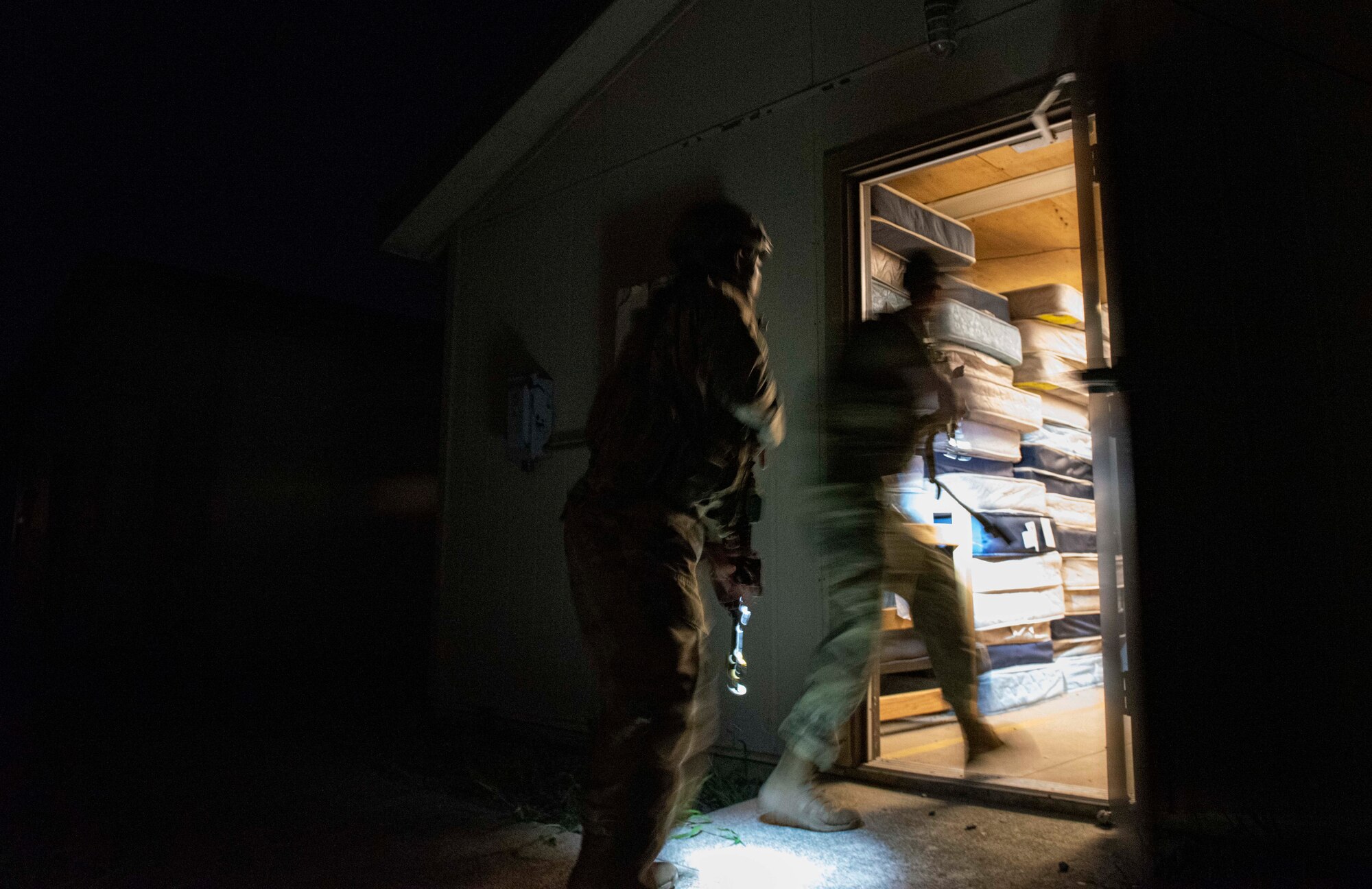 8th Security Forces Squadron Airmen participate in a routine training scenario at Kunsan Air Base, Republic of Korea, July 26, 2021. Members of the 8th SFS broke into teams and cleared buildings on Kunsan AB with the objective of locating and apprehending a criminal role player. These trainings enhance the lethality and readiness of the 8th SFS. (U.S. Air Force photo by Staff Sgt. Gabrielle Spalding)