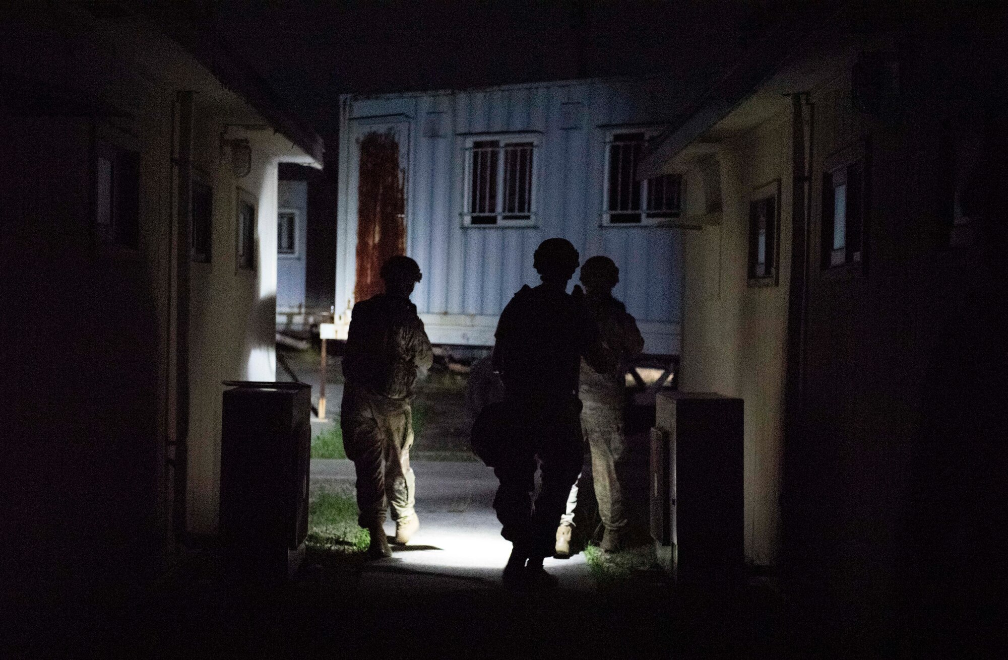 8th Security Forces Squadron Airmen participate in a routine training scenario at Kunsan Air Base, Republic of Korea, July 26, 2021. Members of the 8th SFS broke into teams and cleared buildings on Kunsan AB with the objective of locating and apprehending a criminal role player. These trainings enhance the lethality and readiness of the 8th SFS. (U.S. Air Force photo by Staff Sgt. Gabrielle Spalding)