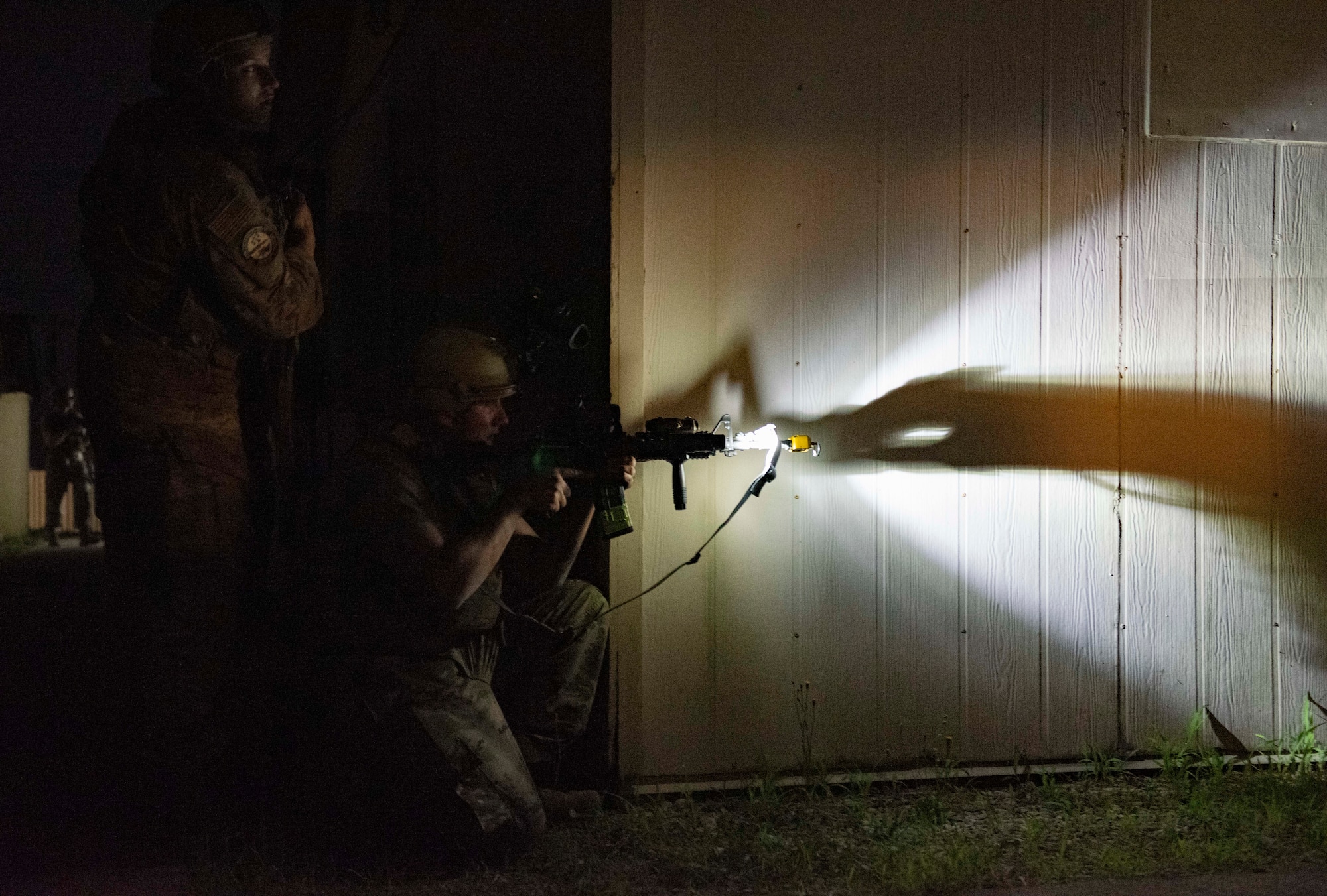 8th Security Forces Squadron Airmen participate in a routine training scenario at Kunsan Air Base, Republic of Korea, July 26, 2021. Members of the 8th SFS broke into teams and cleared buildings on Kunsan AB with the objective of locating and apprehending a criminal role player. These trainings enhance the lethality and readiness of the 8th SFS. (U.S. Air Force photo by Staff Sgt. Gabrielle Spalding)