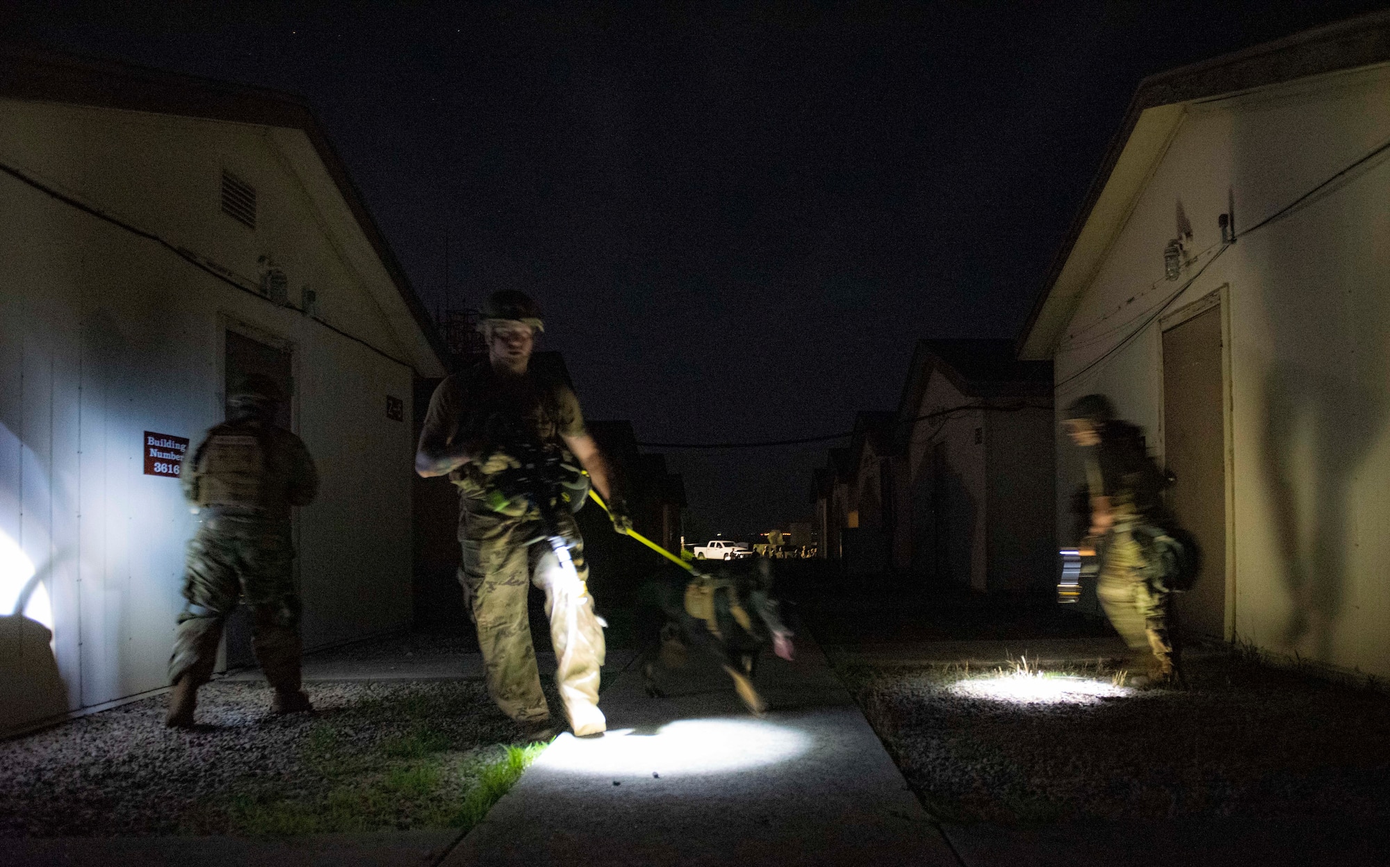 8th Security Forces Squadron Airmen participate in a routine training scenario at Kunsan Air Base, Republic of Korea, July 26, 2021. Members of the 8th SFS broke into teams and cleared buildings on Kunsan AB with the objective of locating and apprehending a criminal role player. These trainings enhance the lethality and readiness of the 8th SFS. (U.S. Air Force photo by Staff Sgt. Gabrielle Spalding)