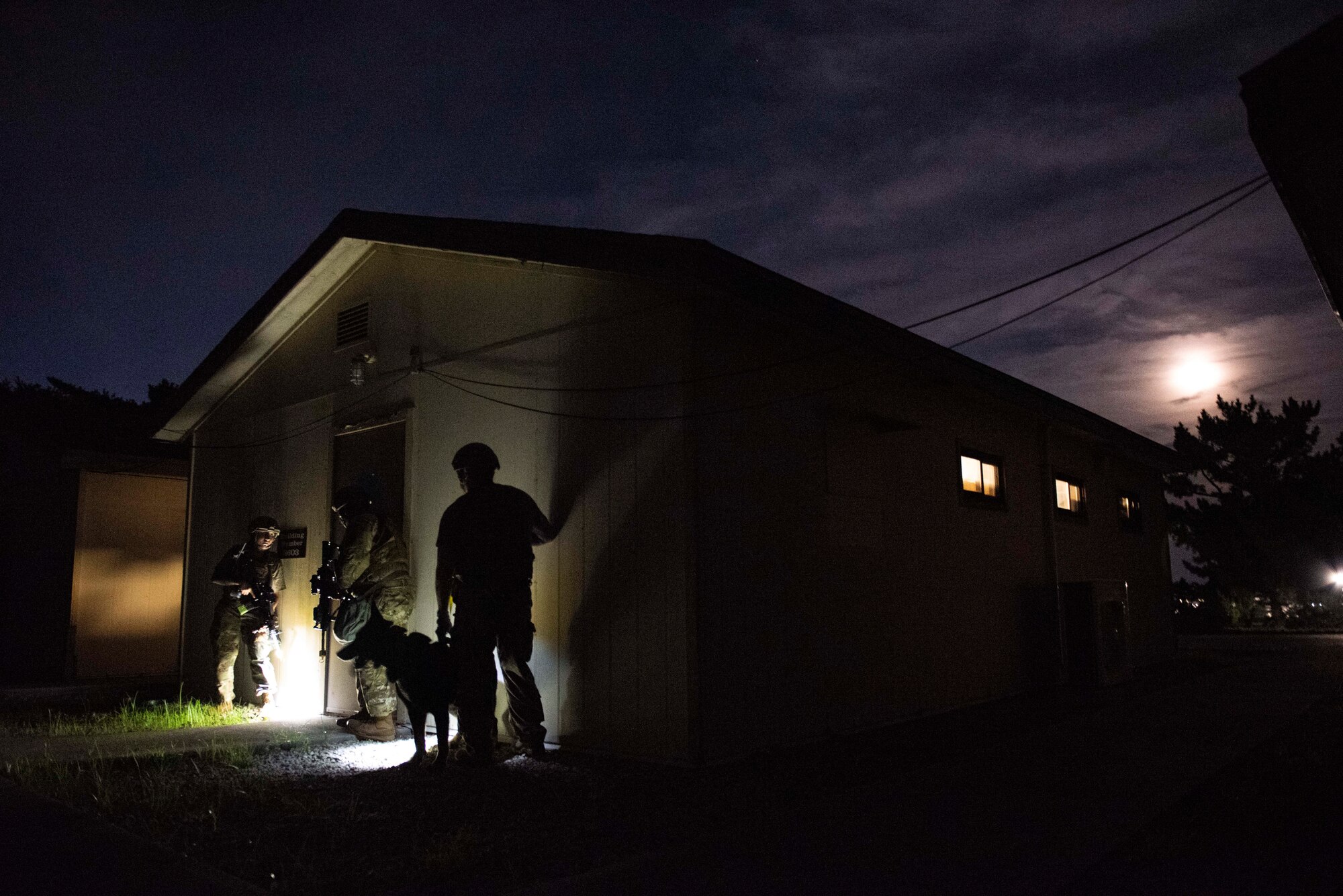 8th Security Forces Squadron Airmen participate in a routine training scenario at Kunsan Air Base, Republic of Korea, July 26, 2021. Members of the 8th SFS broke into teams and cleared buildings on Kunsan AB with the objective of locating and apprehending a criminal role player. These trainings enhance the lethality and readiness of the 8th SFS. (U.S. Air Force photo by Staff Sgt. Gabrielle Spalding)