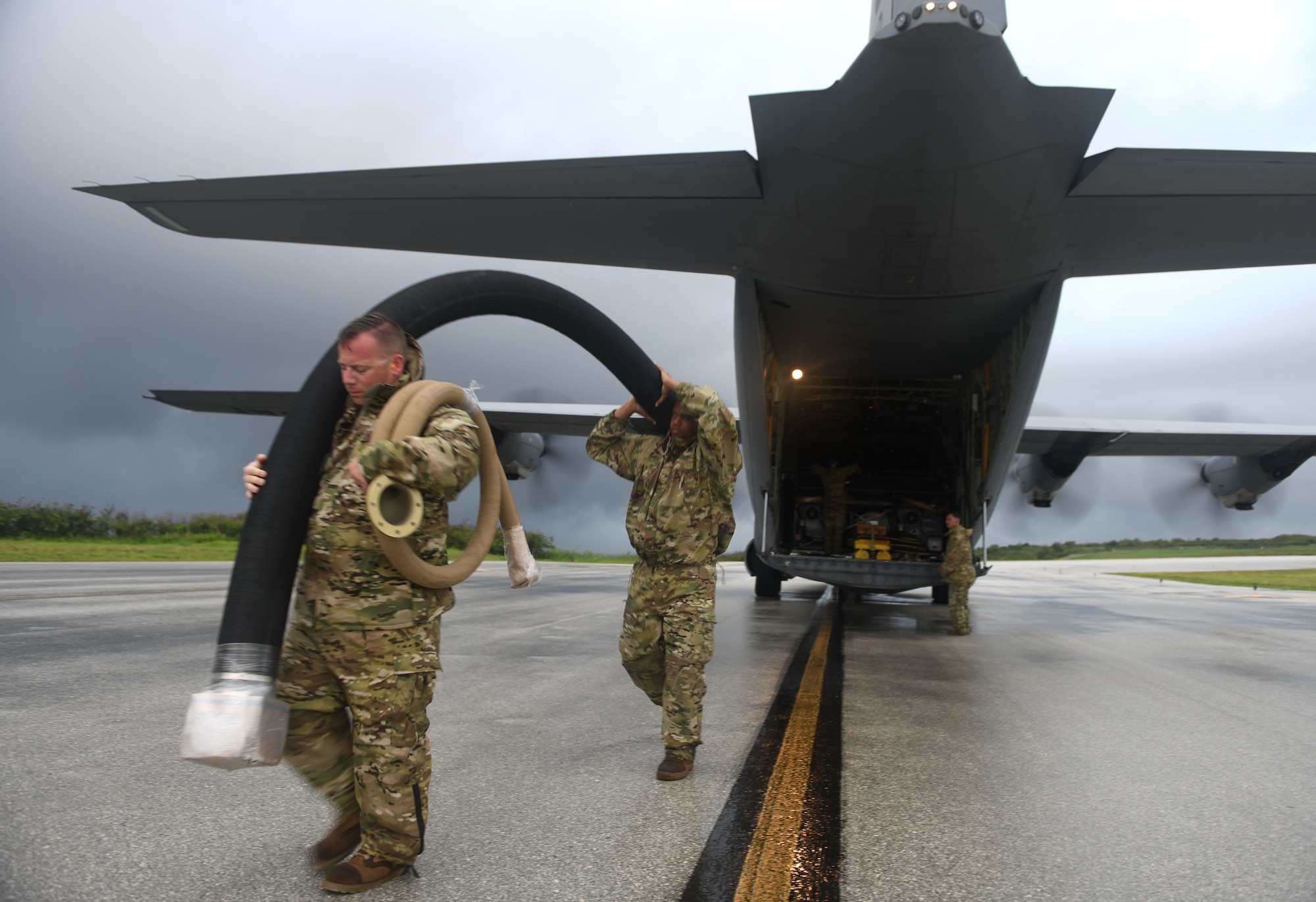 U.S. Air Force Tech. Sgt. Patrick Barlow, 366th Logistics Readiness Squadron acting fuels section chief, deployed from Mountain Home Air Force Base, Idaho, and Senior Airman William Pride, 354th LRS storage attendant, deployed from Eielson AFB, Alaska, unload a fuel hose from a C-130J Super Hercules July 21, 2021, at Tinian International Airport, Tinian, during Pacific Iron 2021. Pacific Iron 2021 is a Pacific Air Forces dynamic force employment operation to project forces into United States Indo-Pacific Command’s area of responsibility in support of a more lethal, adaptive, and resilient force.