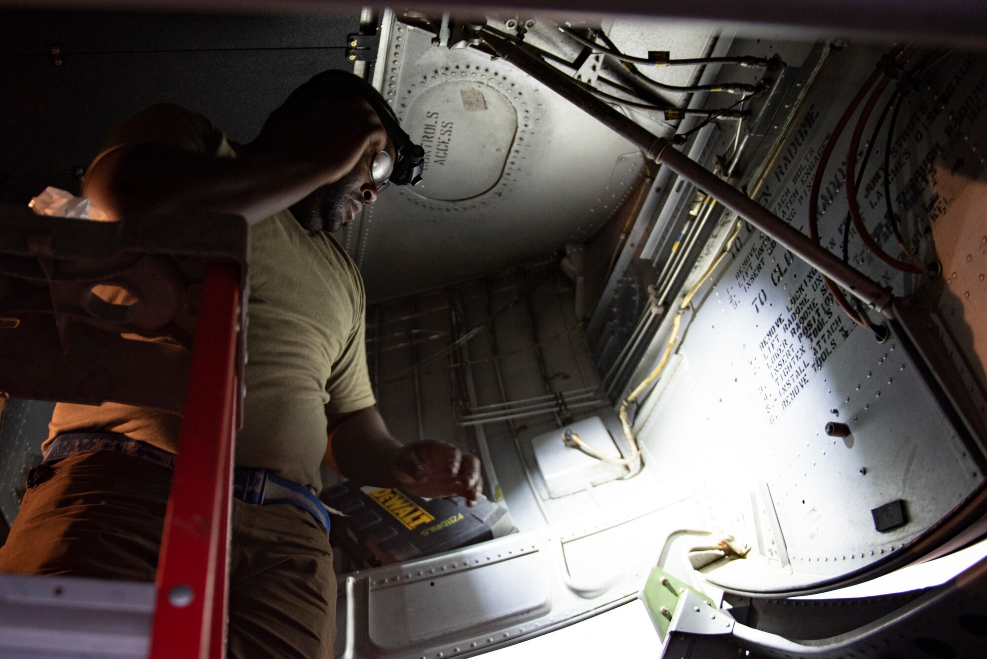 U.S. Air Force Tech. Sgt. Alexander Campbell, an aircraft mechanic assigned to the 386th Expeditionary Aircraft Maintenance Squadron and deployed from Dover Air Force Base, Delaware, works inside a gear panel of a C-130 Hercules at Ali Al Salem Air Base, Kuwait, July 20, 2021. The EAMXS works 24-hour operations year-round to keep the C-130 Hercules’ in flight to accomplish the mission of fight to win today and to provide warfighter support in the area of responsibility. (U.S. Air Force Photo by Senior Airman Helena Owens)