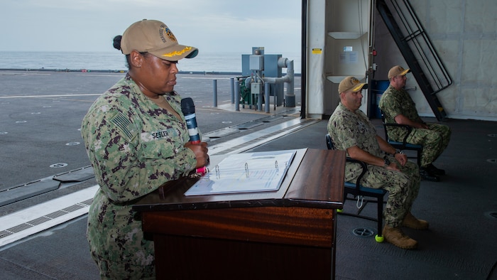 Executive Officer Ernique Sesler, left, Capt. David Gray, center, and Capt. Chad Graham, right, participate in a change of command ceremony aboard the Expeditionary Sea Base USS Hershel "Woody" Williams (ESB 4), July 25, 2021.