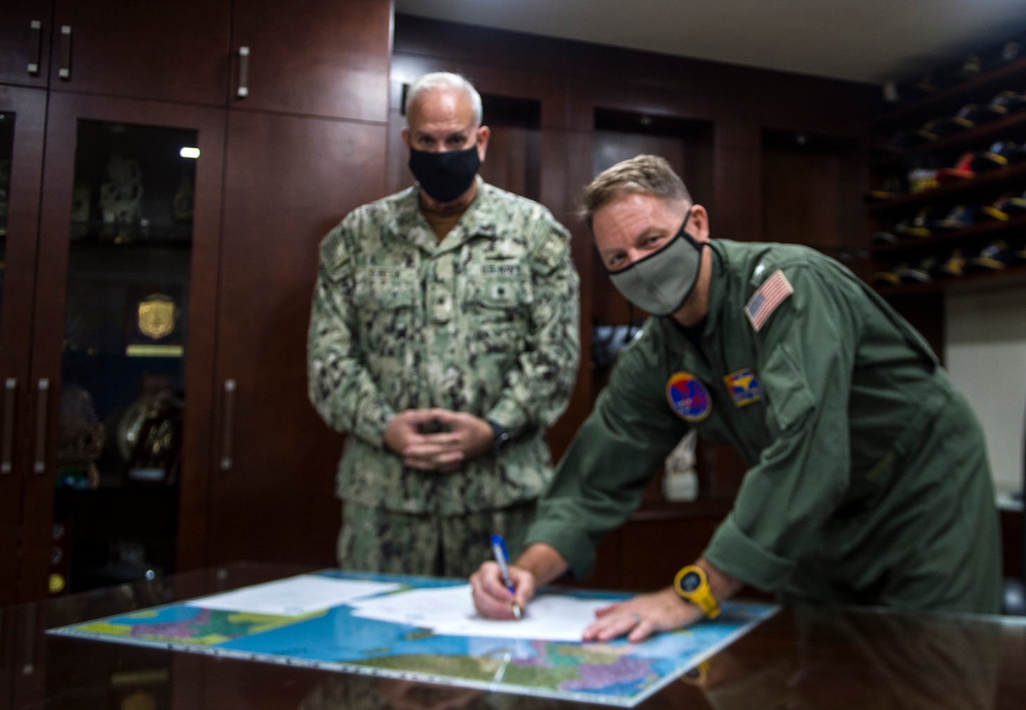 210726-N-HG389-0002 SINGAPORE (July 26, 2021) Rear Adm. Joey Tynch, the outgoing commander of Logistics Group Western Pacific/Task Force 73 (COMLOG WESTPAC/CTF 73), right, and Rear Adm. Philip Sobeck, the incoming commander,  left, sign documents finalizing their change of command, July 26. COMLOG WESTPAC/CTF 73 is 7th Fleet's provider of combat-ready logistics, operating government-owned and contracted ships to keep units throughout the Fleet fueled, fed and in the fight. (U.S. Navy photo by Petty Officer 2nd Class Brandon Parker)