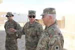 Sgt. Ismael Pulido, electronic warfare NCO, Chief Warrant Officer 2 Anthony Meneely, Chief Warrant Officer 4 Douglas Montgomery discuss Counter Radio-Controlled Improvised Explosive Device Warfare system training at Camp Buehring, Kuwait. Pulido, Meneely and Montgomery are the Task Force Phoenix Cyberspace Electromagnetic Activities cell.