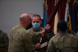 Col. Neil T. Roeder, incoming commander, 3rd Medical Command Forward "Desert Medics," receives the colors from Maj. Gen. Chris Field, deputy commanding general – operations, U.S. Army Central, during a transfer of authority ceremony at Camp Arifjan, Kuwait, July 16, 2021. Roeder will lead the Detachment 10 unit here in theater.