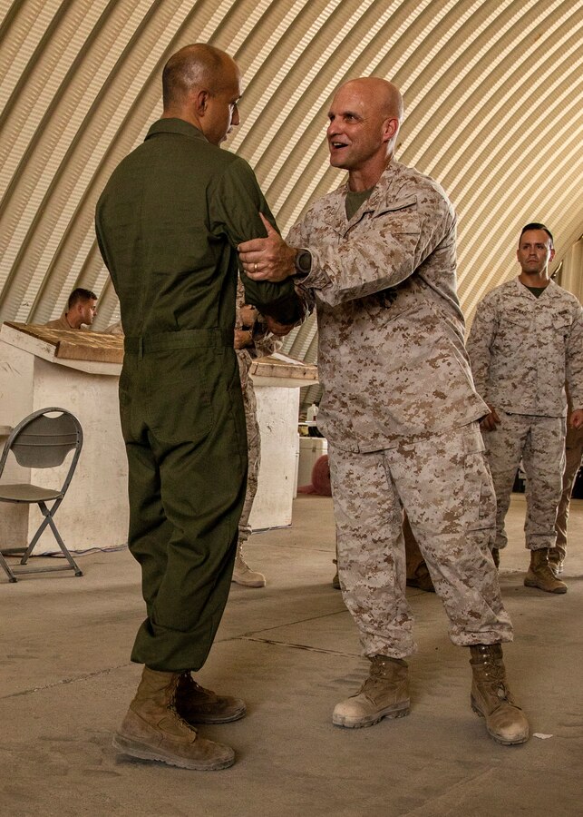 Lt. Gen. David G Bellon, Commander, Marine Forces Reserve and Marine Forces South, presents a challenge coin to a Marine during a visit to Integrated Training Exercise (4-21) at Marine Corps Air Ground Combat Center Twentynine Palms, California on July 22, 2021. Lt. Gen. Bellon visited all elements of Marine Air Ground Task Force (MAGTF) 25 and recognized high performing Marines and Sailors as they continue to provide vital support to the MAGTF in execution of ITX. (U.S. Marine Corps photo by Lance Cpl. Samwel tabancay)