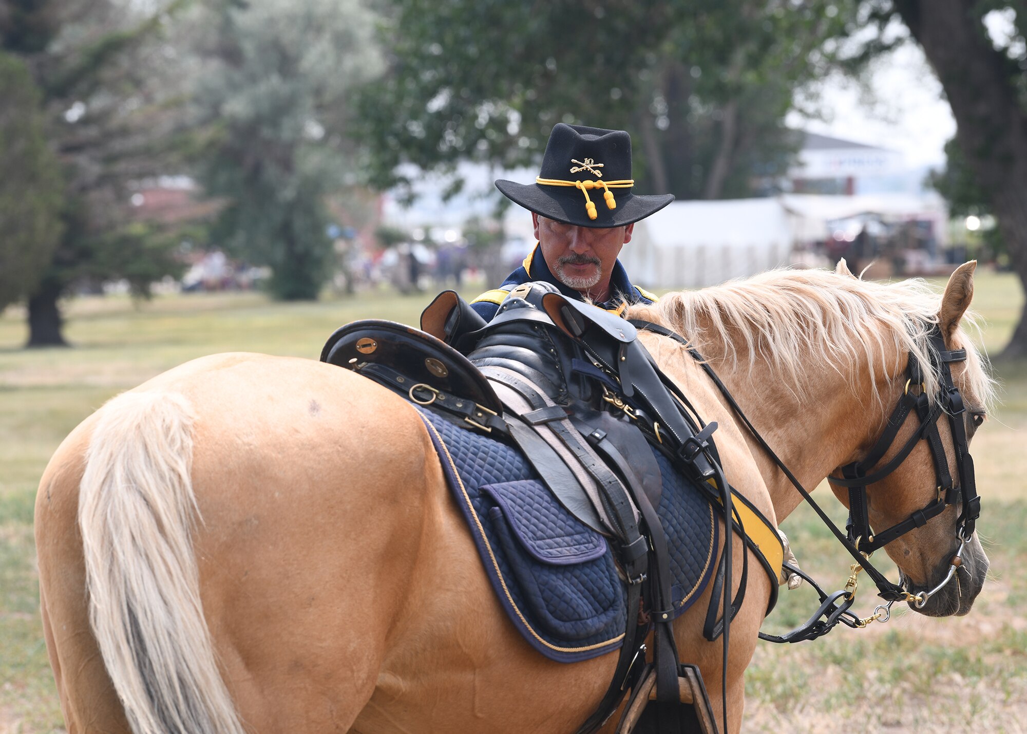 Volunteer reenactor Scott Johns dismounts his horse July 24, 2021, during Fort D.A. Russell Days on F.E. Warren Air Force, Wyoming. Fort D.A. Russell Days is a time for F.E. Warren Air Force Base to share its history and heritage with the community. ( U.S. Air Force photo by Airman 1st Class Darius Frazier.)