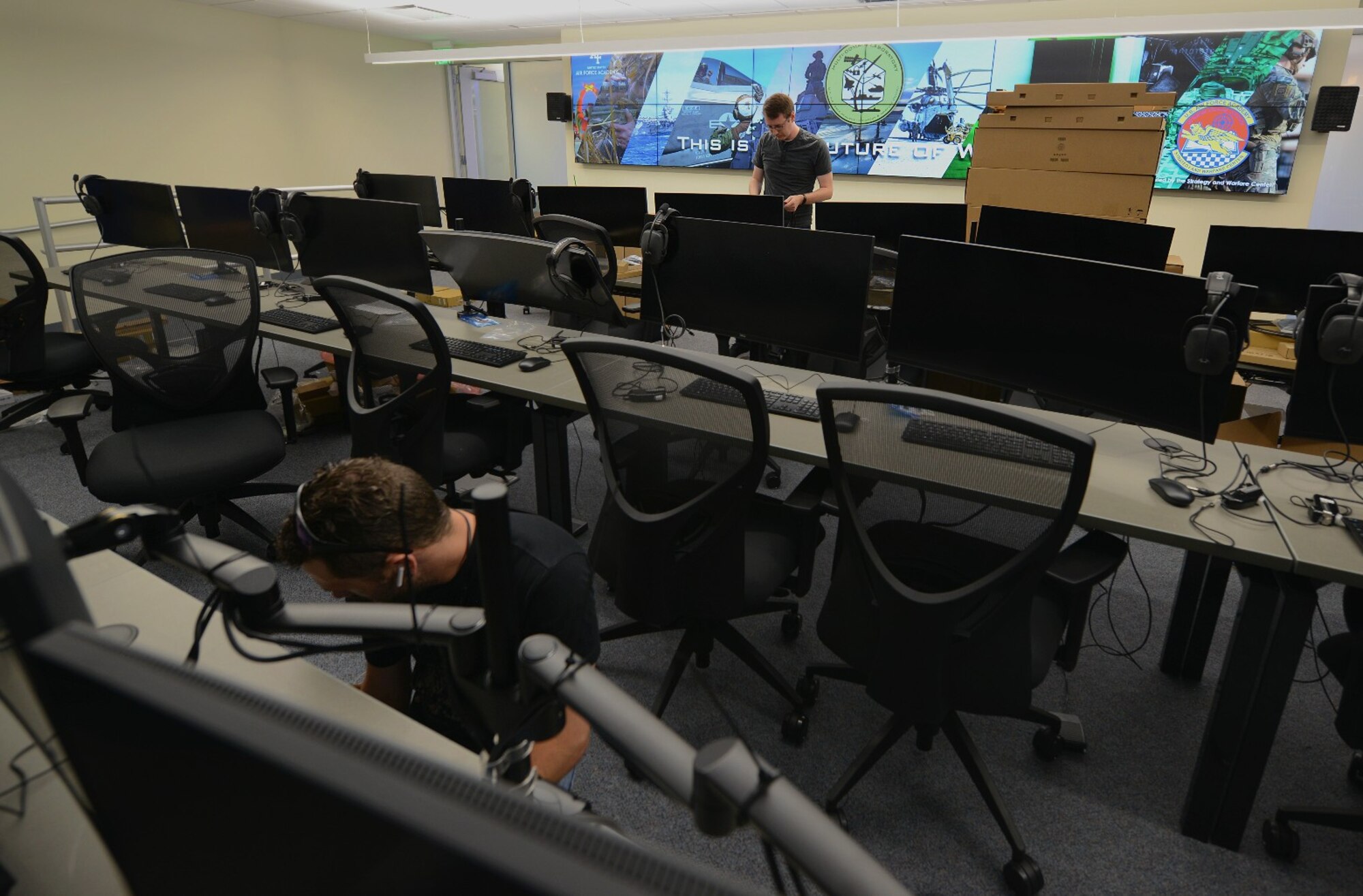 Contractors install computers in the multi domain laboratory at the U.S. Air Force Academy, July 22, 2021.