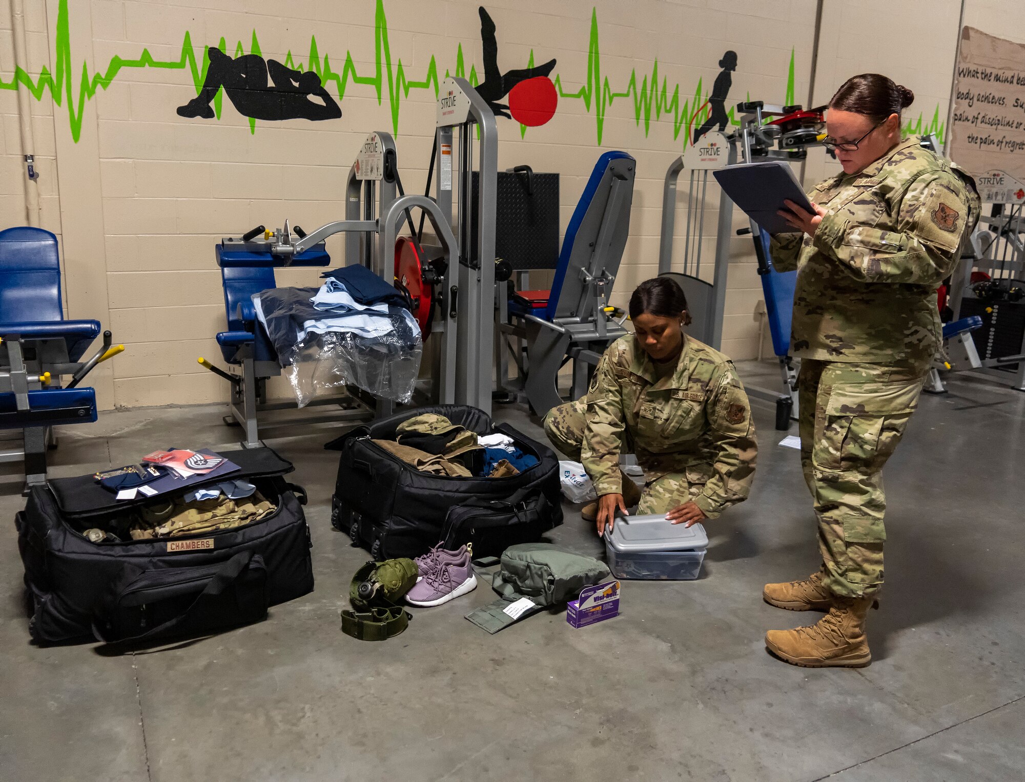 Tech. Sgt. Kayla Hemmesch, Dover Fisher House for Families of the Fallen manager with Air Force Mortuary Affairs Operations, double checks individual deployment bags at Dover Air Force Base, Delaware, July 19, 2021. Each Airman is required to check and sign off on his or her mobility bag to ensure the proper equipment is in their bag.  (U.S. Air Force photo by Jason Minto)