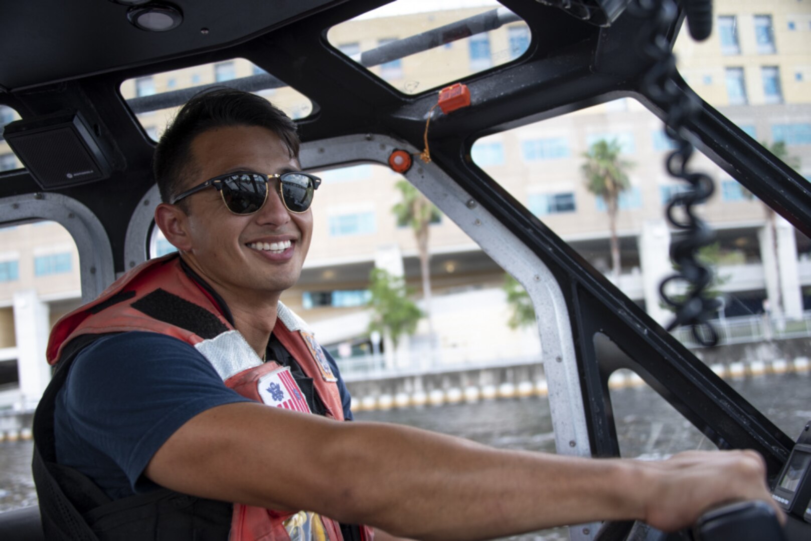 Coast Guard Petty Officer 2nd Class Alan Moriwaki, a boatswain’s mate at Coast Guard Station St. Petersburg, serves at the coxswain on a 29-foot Response Boat – Small II during Tampa Bay Lightning’s Stanley Cup Championship Boat Parade, Tampa, Florida, July 12, 2021. The Coast Guard collaborated with its interagency partners to ensure the movement of vessels in the parade, and to keep the boating public safe during the celebration. (U.S. Coast Guard photo by Petty Officer 1st Class Lisa Ferdinando)