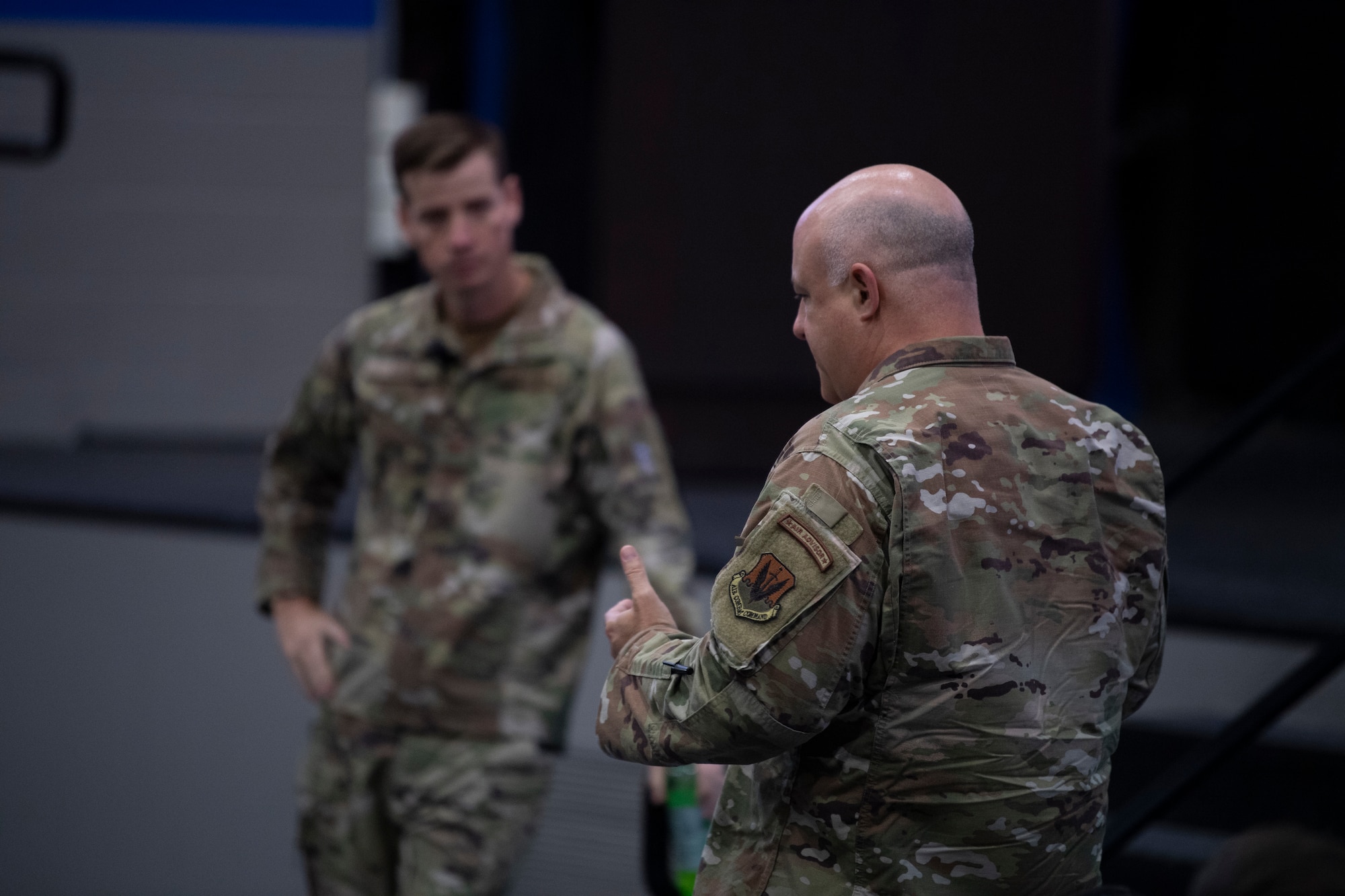 A photo of two Airmen talking.