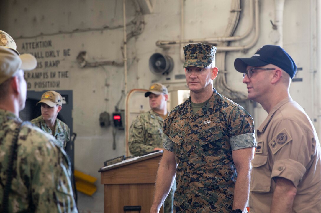 The 19th Sergeant Major of the Marine Corps, Sgt. Maj. Troy E. Black, greats U.S. Navy sailors during a tour of the USS Mesa Verde, Norfolk, Va, July 14, 2021. The Sergeant Major of the Marine Corps received a tour of the ship from the Marine ship team. The Marine ship team builds integration between the Marine Corps and the Navy to facilitate operations while underway. (U.S. Marine Corps photo by Sgt. Victoria Ross)