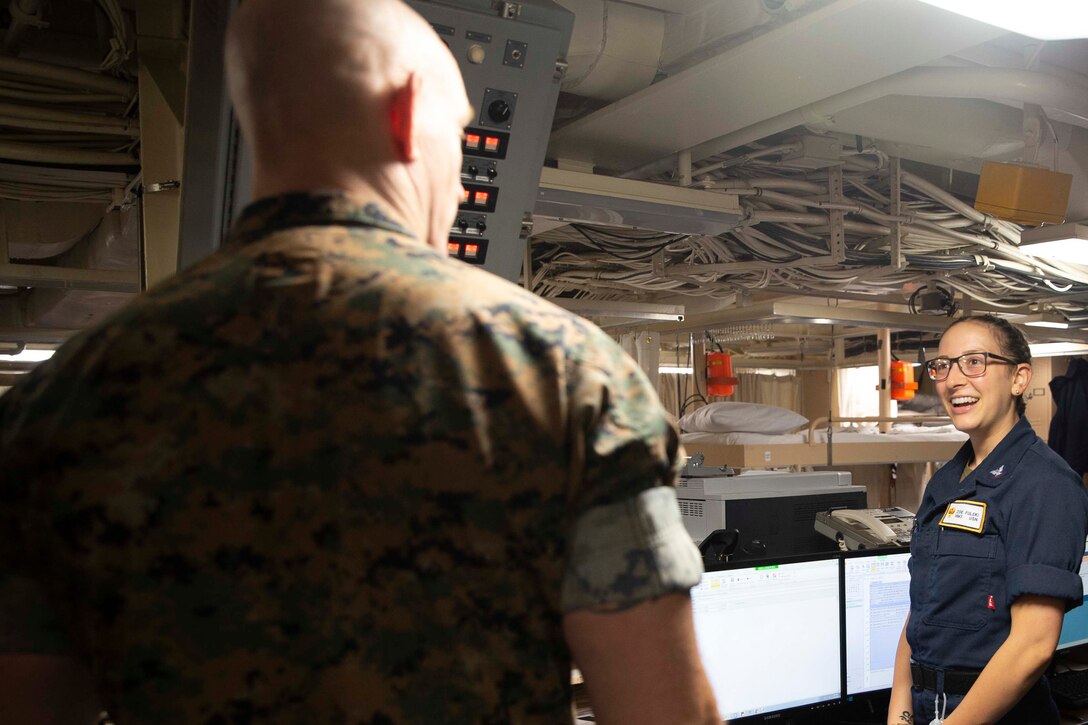 The 19th Sergeant Major of the Marine Corps, Sgt. Maj. Troy E. Black, greets a U.S. Navy sailor during a tour of the USS Mesa Verde, Norfolk, Va, July 14, 2021. The Sergeant Major of the Marine Corps received a tour of the ship from the Marine ship team. The Marine ship team builds integration between the Marine Corps and the Navy to facilitate operations while underway. (U.S. Marine Corps photo by Sgt. Victoria Ross)