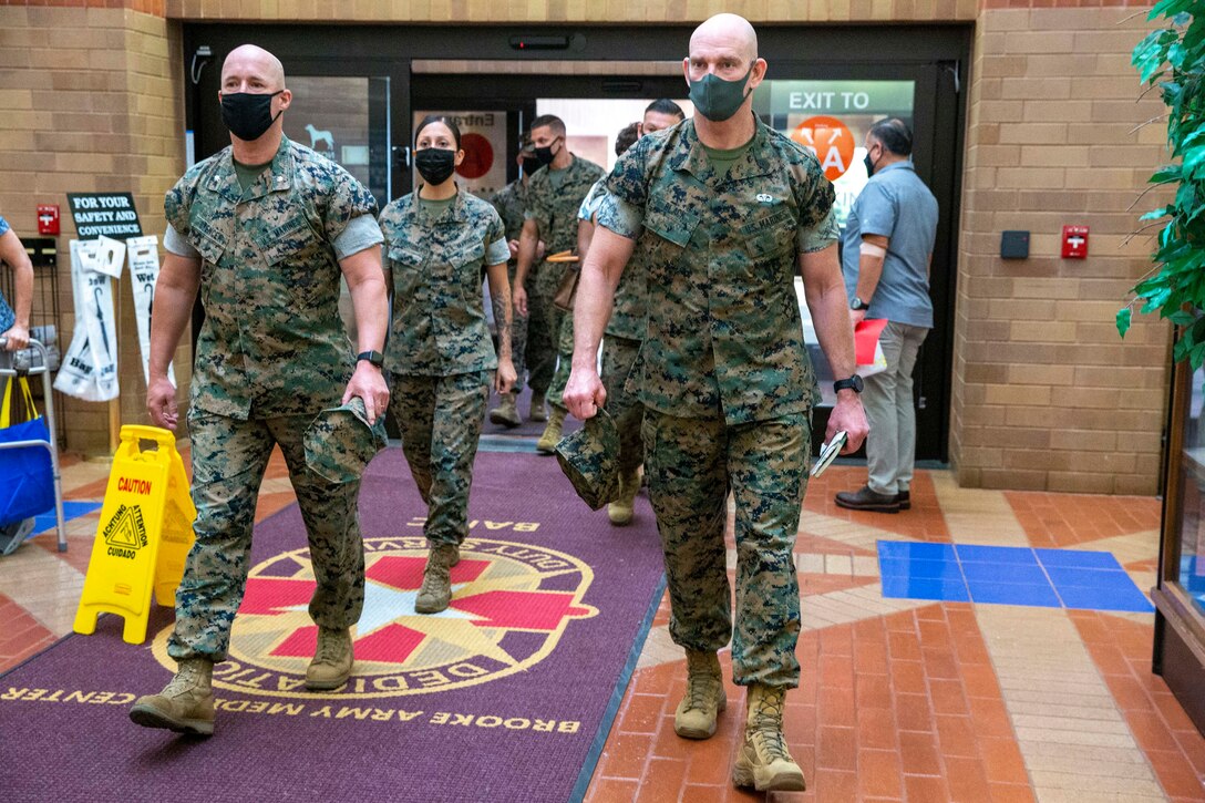 The 19th Sergeant Major of the Marine Corps, Sgt. Maj. Troy E. Black, tours the Brooke Army Medical Center, San Antonio, Texas, July 20, 2021. The Sergeant Major of the Marine Corps conducted the tour to get an update on the research and recovery facilities that support Wounded Warrior Battalion-East, San Antonio detachment. Wounded Warrior Battalion supports recovery, and non-medical care of combat and non-combat wounded, ill, and injured Marines, and sailors attached to Marine units, and their family members in order to maximize their recovery as they return to duty or transition to civilian life. (U.S. Marine Corps photo by Sgt. Victoria Ross)