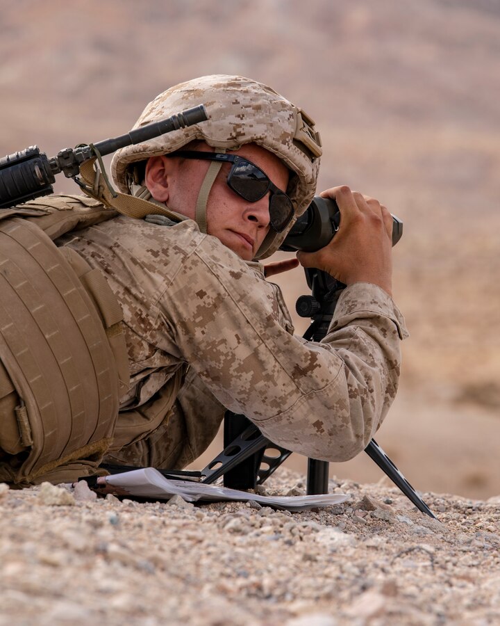 Lance Cpl. Reece Ackerman, a forward air observer with 3rd Battalion, 25th Marines observes targets during Fire Support Coordination Exercise (FSCEX) 1, a sub-event of Integrated Training Exercise (ITX) 4-21 at Marine Corps Air Ground Combat Center, Twentynine Palms, California on July 22, 2021. FSCEX allows Reserve Marines to coordinate various fires assets from across Marine Air Ground Task Force 25 to eliminate enemy positions in a simulated combat environment. (U.S. Marine Corps photo by Sgt. JVonnta Taylor)