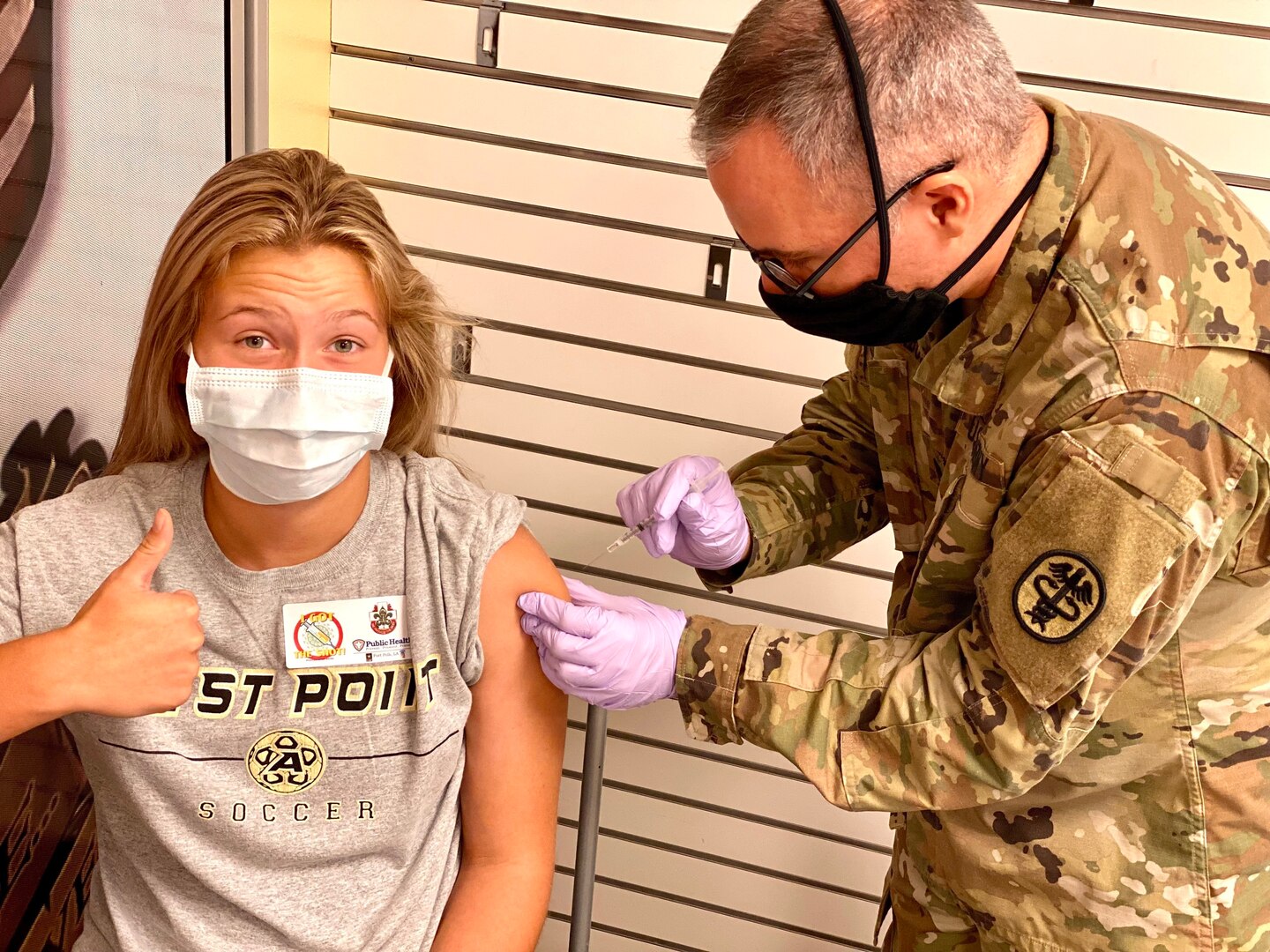 Oliva Chapman, 13, gives a thumbs up as Spc. Steven Blackburn administers her Pfizer COVID-19 vaccine during a vaccination clinic at the Fort Polk Main Exchange on July 24.