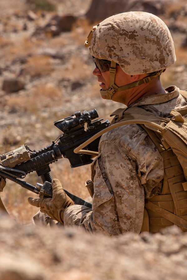 A Marine with Kilo Company, 3rd Battalion, 25th Marines, 4th Marine Division, calls in enemy positions on Range 400 during Integrated Training Exercise (ITX) 4-21 at Marine Corps Air Ground Combat Center, Twentynine Palms, California on July 23, 2021.Range 400 is a company-sized live-fire assault range that requires complex coordination of fires, producing combat-ready Reserve Marines prepared to augment and reinforce the Active Component. (U.S. Marine Corps photo by Sgt. JVonnta Taylor)