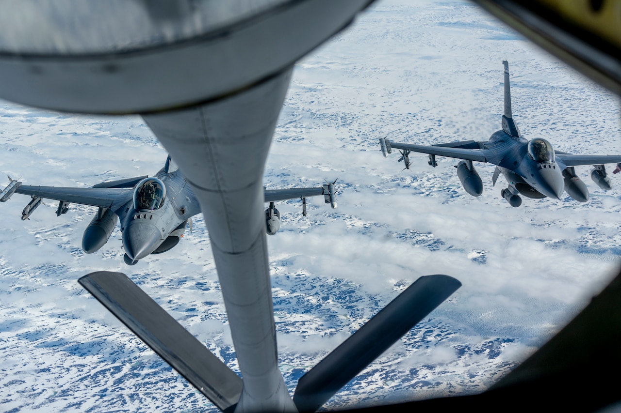 Three planes fly in the air.