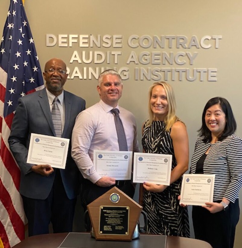 2 men and 2 women pose with their award certificates