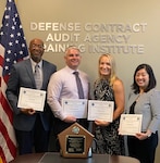 2 men and 2 women pose with their award certificates