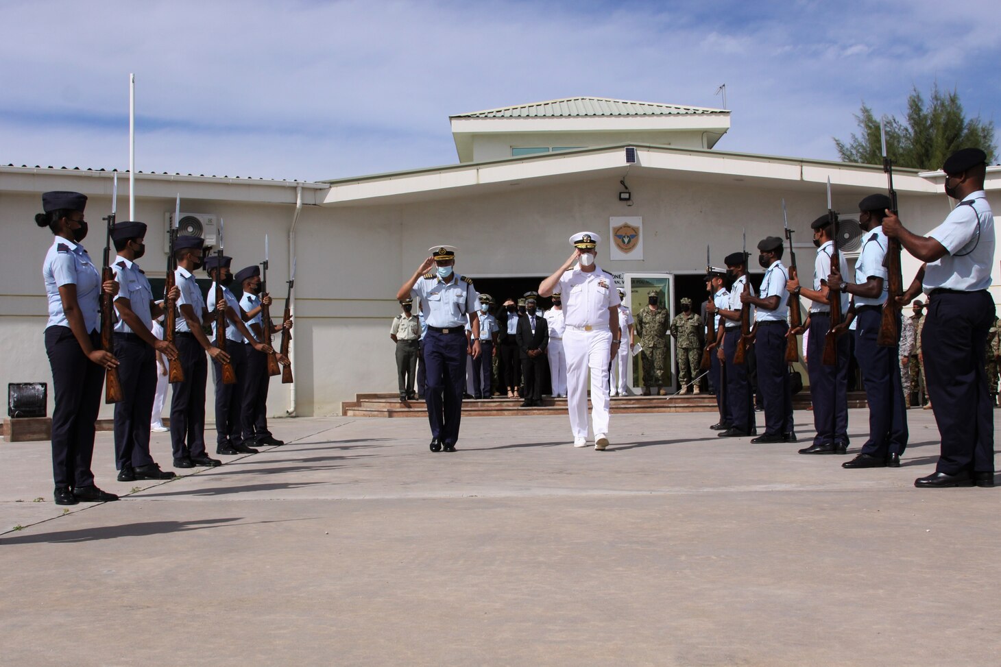 (July 26, 2021) Lt. Col. Jean Attala, Commander, Seychelles Coast Guard, left, and Rear Adm. Jeffrey Spivey, Director, Maritime Partnership Program, U.S. Naval Force Europe-Africa, U.S. Sixth Fleet, render honors during the opening ceremony of exercise Cutlass Express 2021 held at the Seychelles Coast Guard Academy in Victoria, Seychelles, July 26, 2021. Cutlass Express is designed to improve regional cooperation, maritime domain awareness and information sharing practices to increase capabilities between the U.S., East African and Western Indian Ocean nations to counter illicit maritime activity.