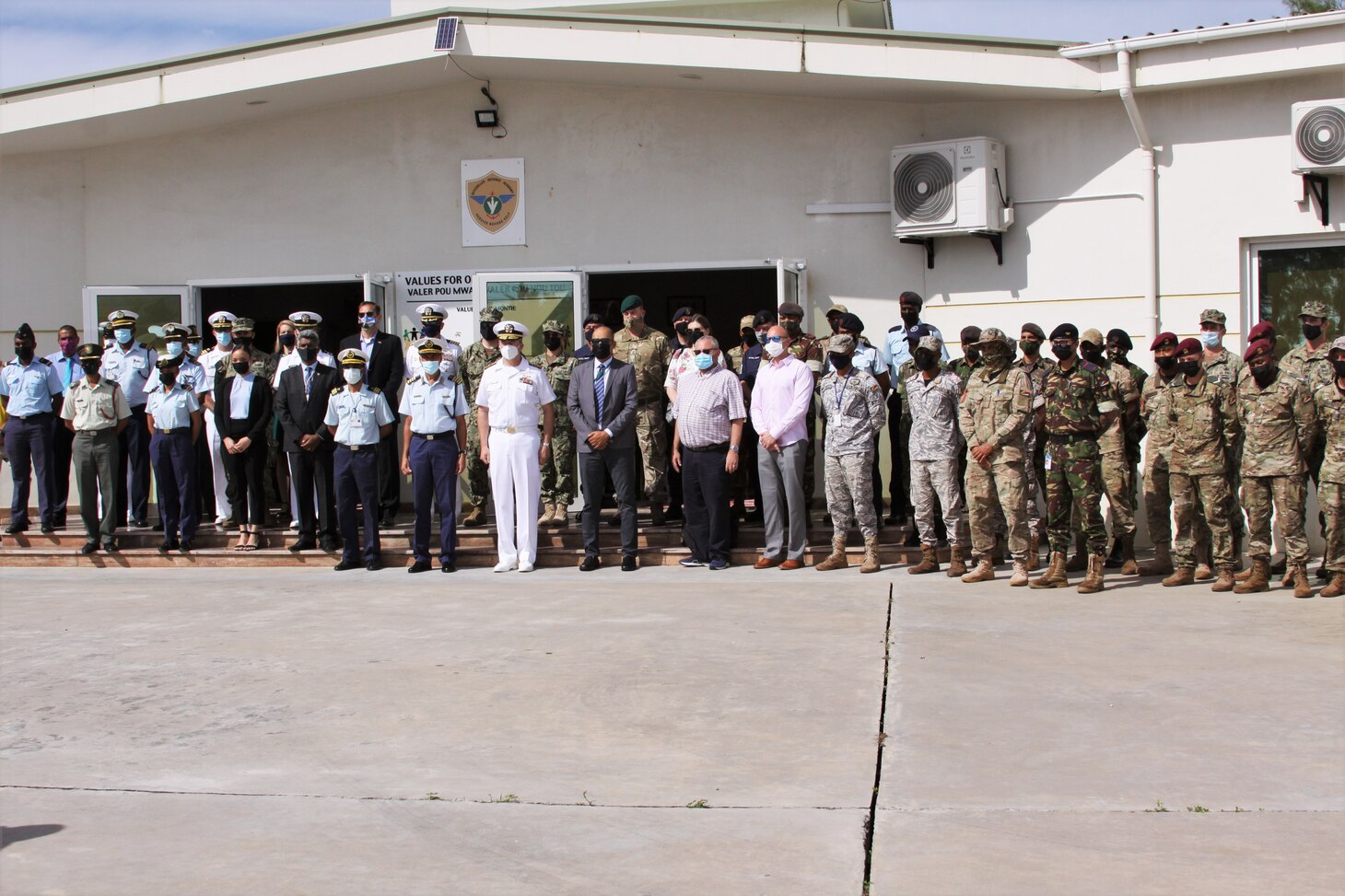 (July 26, 2021) Rear Adm. Jeffrey Spivey, Director, Maritime Partnership Program, U.S. Naval Force Europe-Africa, U.S. Sixth Fleet, center, takes a group photo with participating nations during the opening ceremony of exercise Cutlass Express 2021 held at the Seychelles Coast Guard Academy in Victoria, Seychelles, July 26, 2021. Cutlass Express is designed to improve regional cooperation, maritime domain awareness and information sharing practices to increase capabilities between the U.S., East African and Western Indian Ocean nations to counter illicit maritime activity.