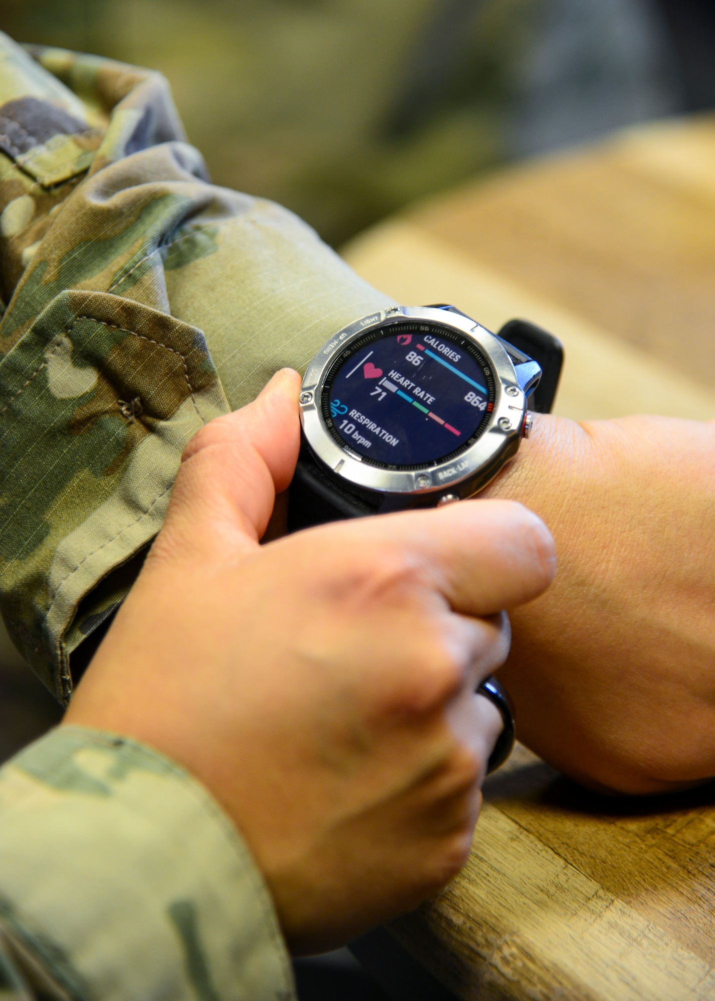 Tech. Sgt. Carmen Turcios Munoz, Ellington Airman Leadership School instructor, shows off a smart watch which provides Airmen biofeedback to improve physical exercise, their sleep, their timing of when to tackle which tasks and other benefits. (Air Force photo by Gary Hatch)