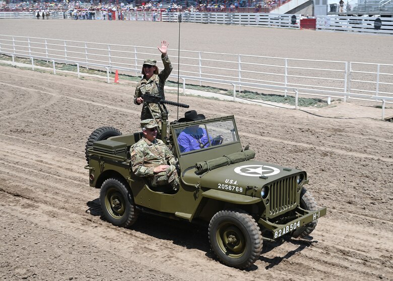 Col. Barry Deibert, 153rd Airlift Wing commander, and Col. Catherine Barrington, 90th Missile Wing commander, enters Frontier Park during the grand entrance to Military Monday at Frontier Park in Cheyenne, Wyoming, July 26, 2021. Military Monday honors those serving in the local community and provides an opportunity to showcase the strong relationship between the base and the local community. (U.S. Air Force photo by Glenn S. Robertson)