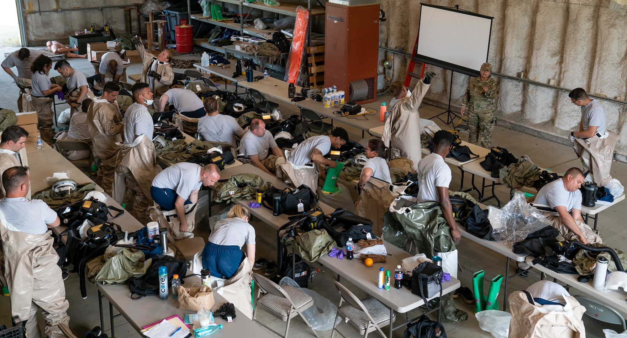 Airmen don decontamination gear as they begin a training exercise.