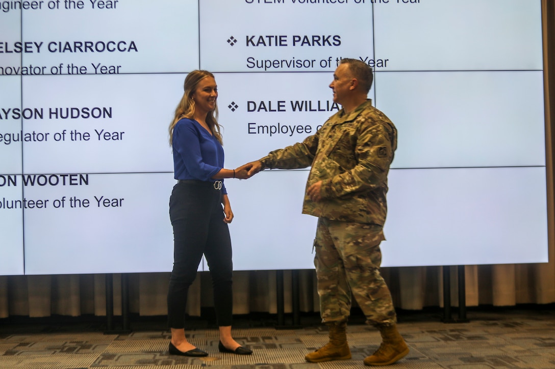 The Galveston District's “Innovator of the Year," Kelsey Ciarrocca, receives a commander's coin from District Commander Col. Tim Vail during an awards ceremony held July 1, 2021. Ciarrocca, a cartographer in Galveston’s Real Estate Division, implemented a cloud-based work management platform within the district and Southwest Division to help streamline real estate acquisition procurements and reporting. Ciarrocca’s innovation allowed for instant access to real time data, reports and dashboards.