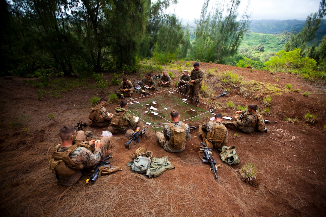 U.S. Marine Corps infantry squad leaders assigned to School of Infantry West, Detachment Hawaii, use a terrain model during the Advanced Infantry Course aboard Kahuku Training Area, Hawaii, July 20, 2016. AIC is intermediate training designed to enhance and test the Marine's skills and leadership abilities as squad leaders in a rifle platoon.