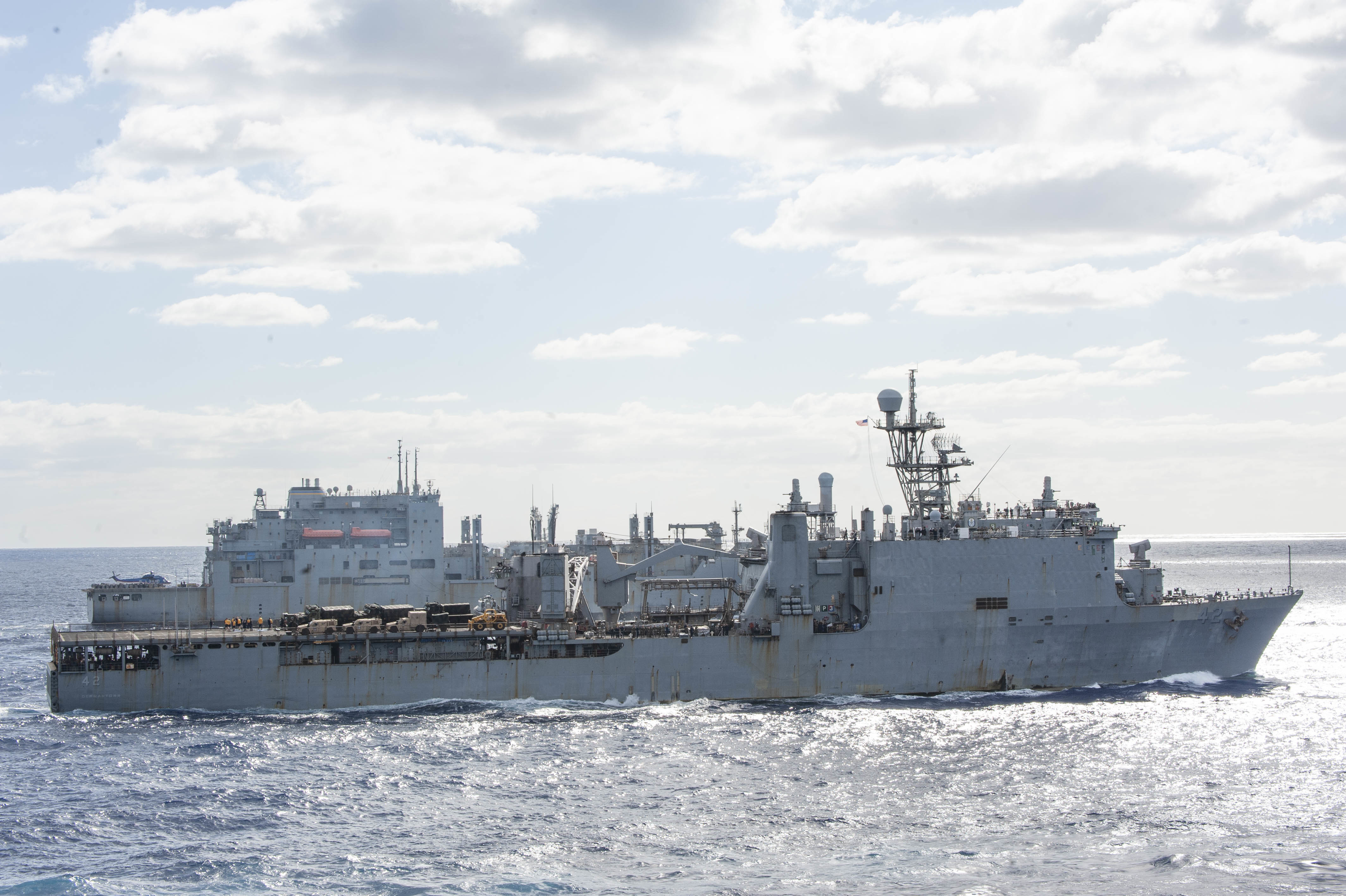USS Germantown (LSD 24), foreground, and USNS Alan Shepard (T-AKE 3) steam in formation alongside partner nations and allies during Talisman Sabre (TS) 21.