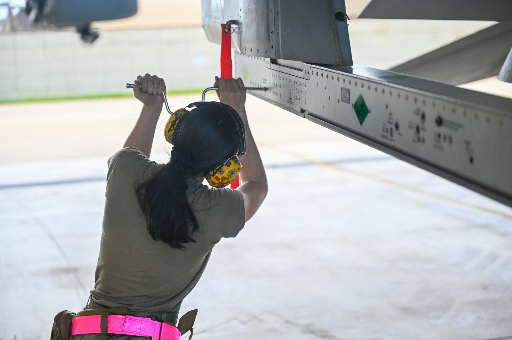 An Airman performs a maintenance check on an airplane.
