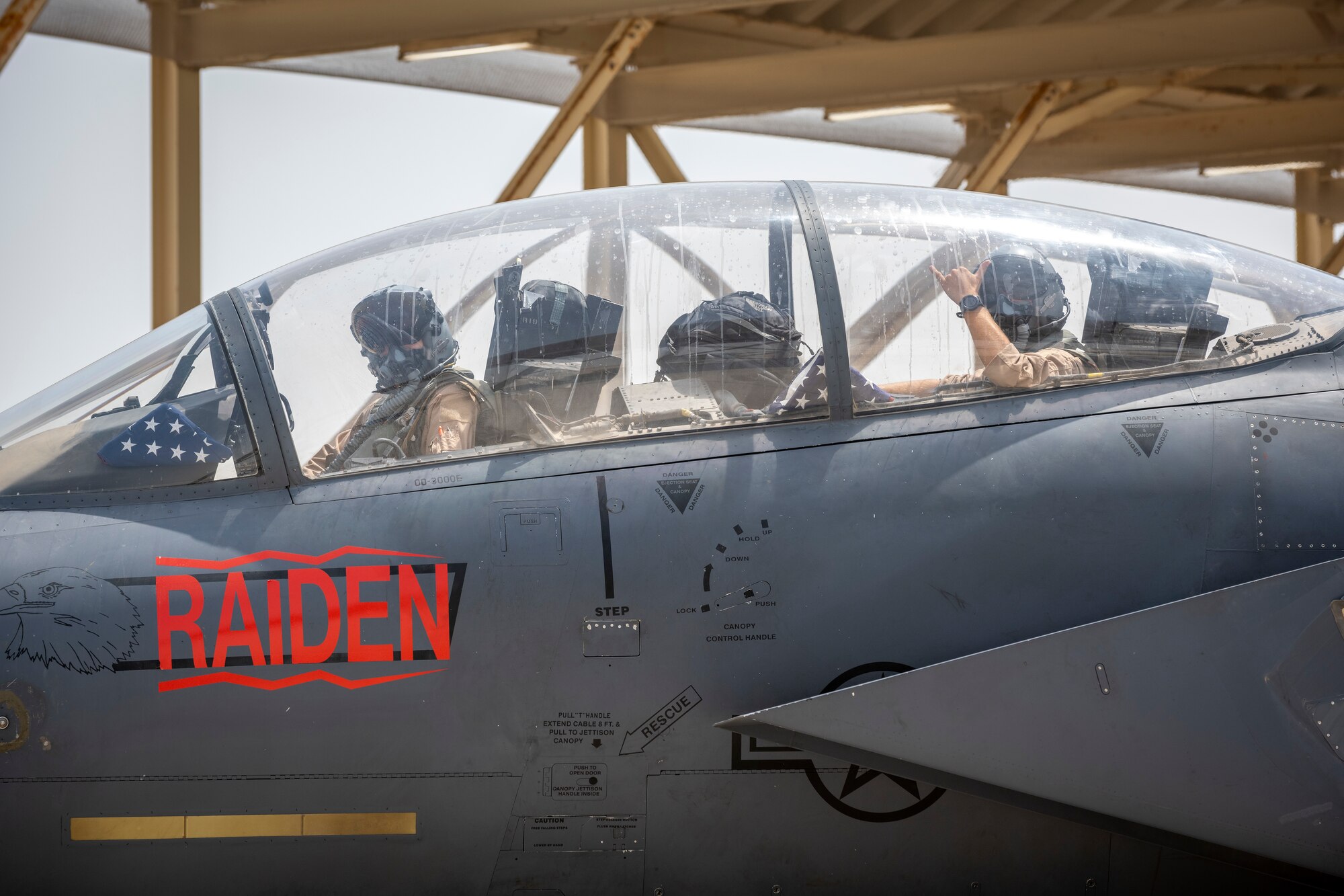 Pilots in cockpit of F-15E wave goodbye