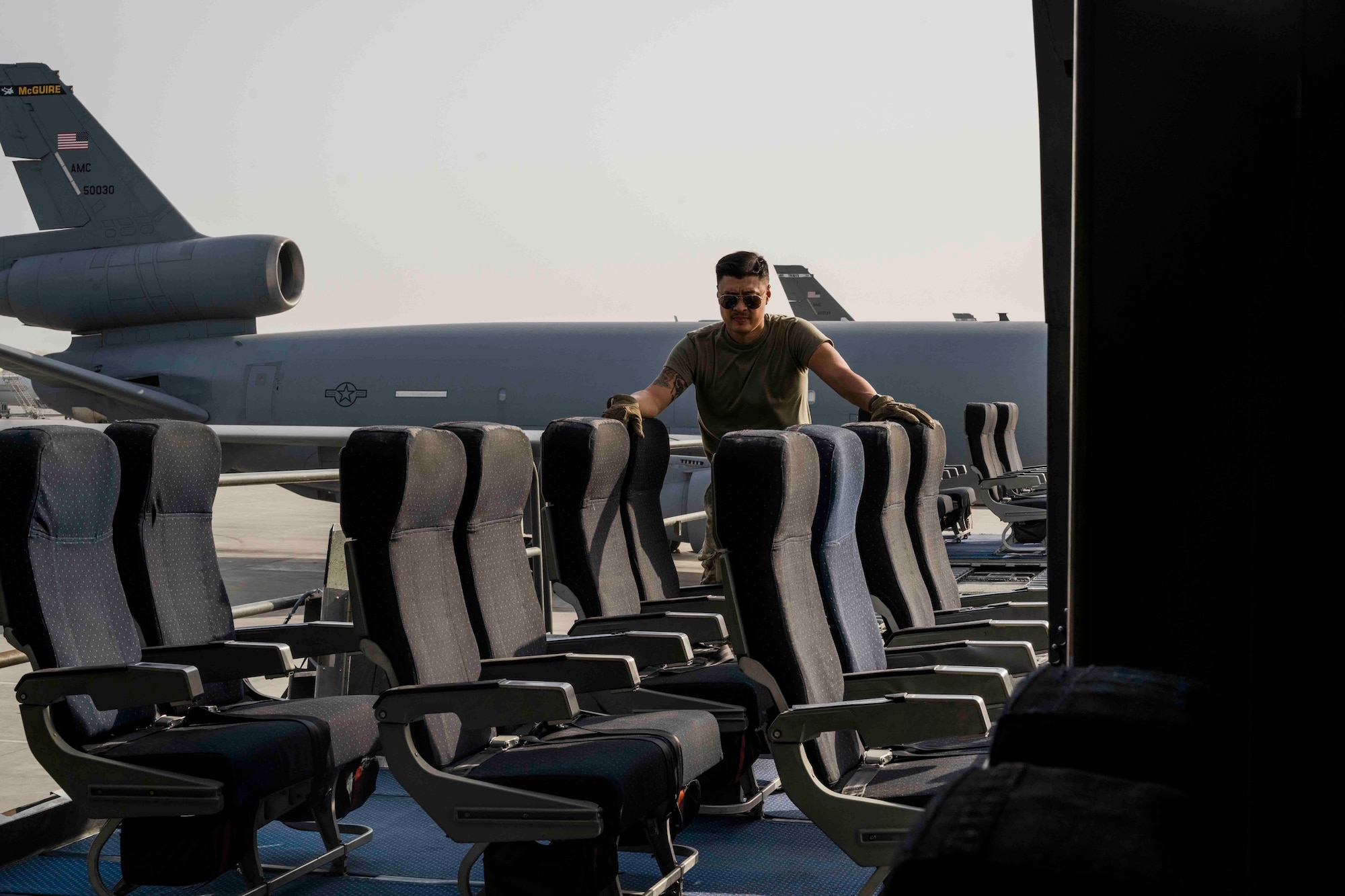 Airman loads passenger seating onto an aircraft