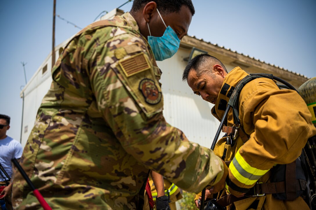 U.S. Air Force Airmen of the 380th Expeditionary Fire Department, conducts an exercise with base leadership at Al Dhafra Air Base, United Arab Emirates, July 24, 2021.